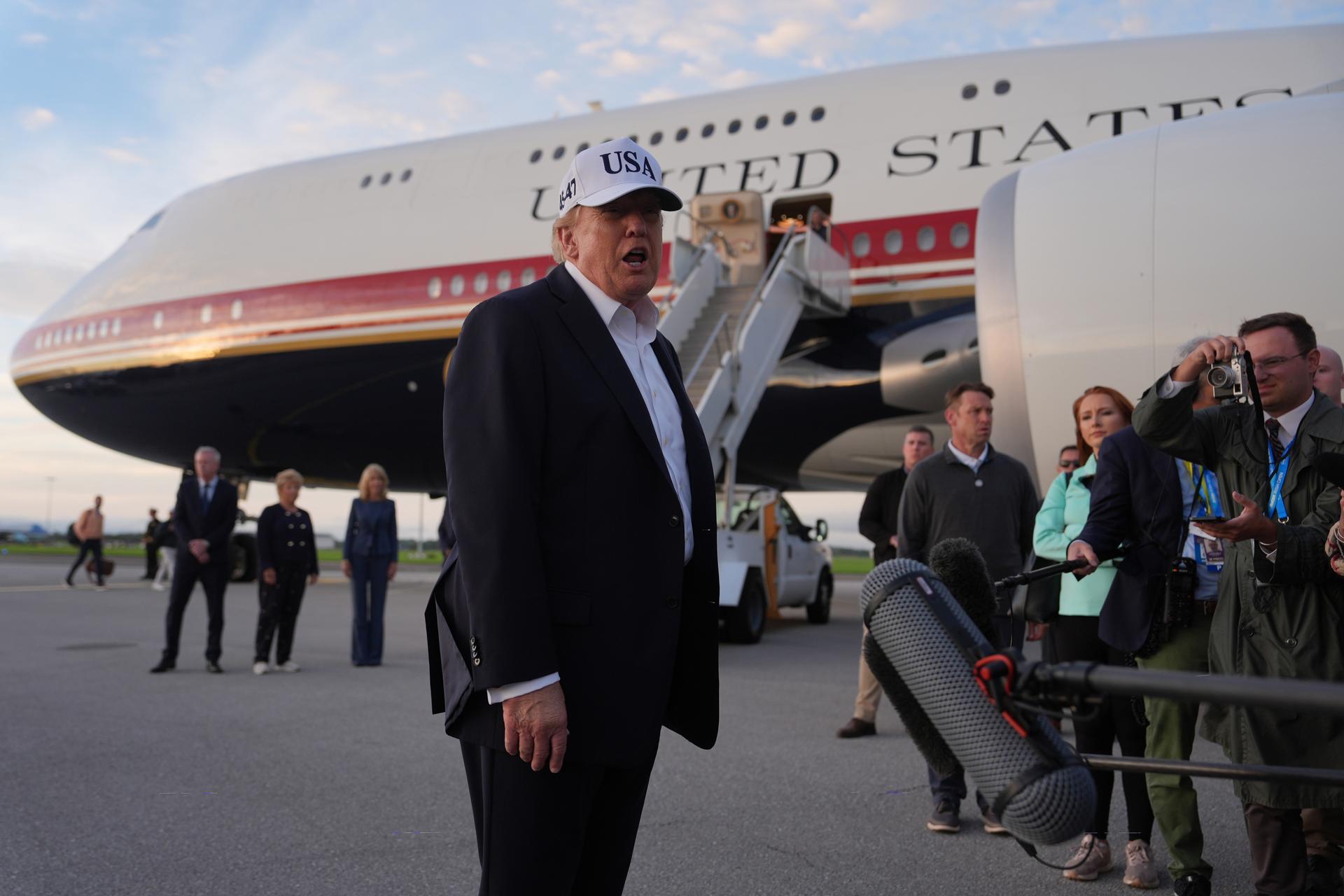 President Donald Trump speaks with journalists prior to boarding Air Force One at Shannon Airport in Shannon, Ireland, Sunday. 