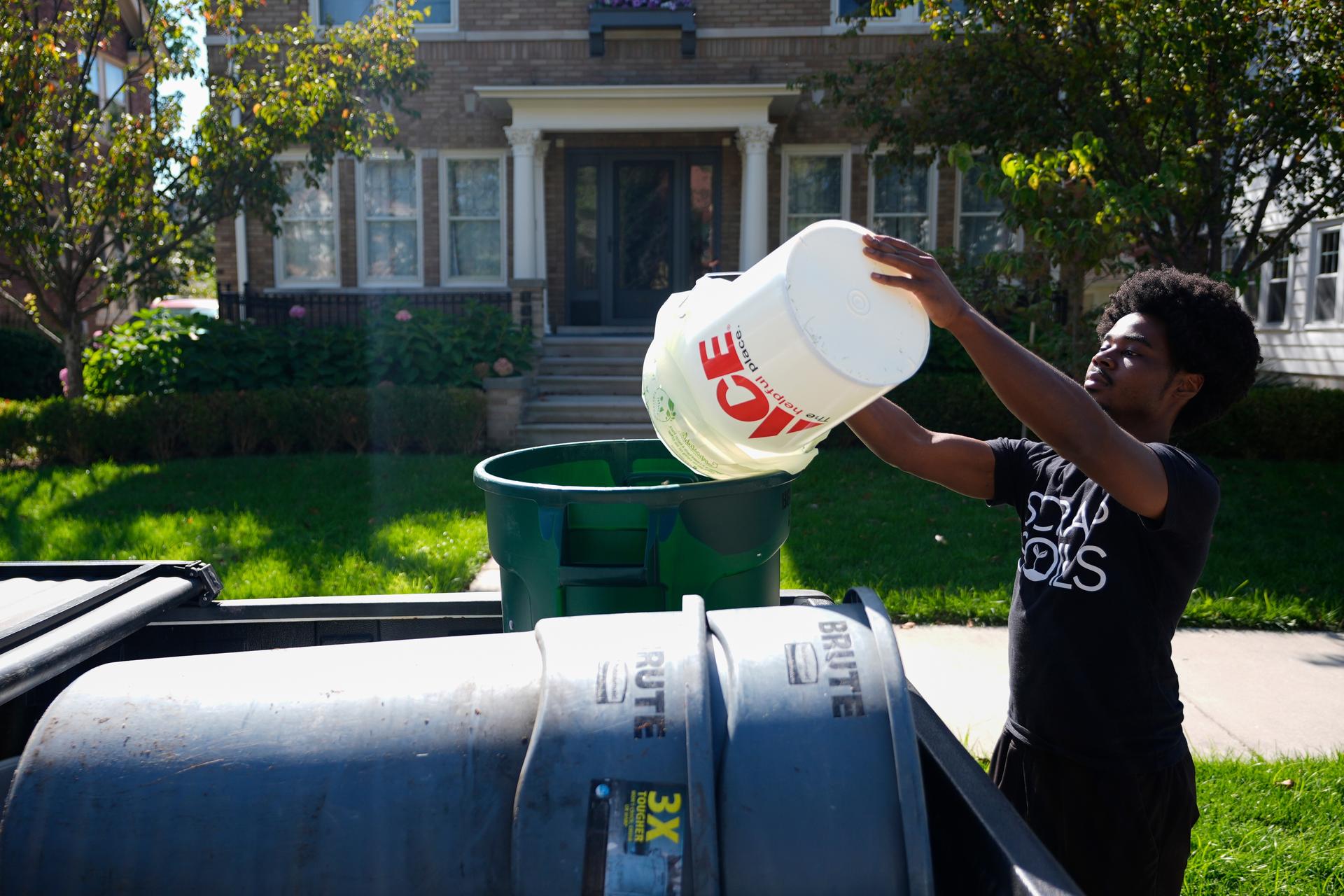 Ricky Blanding, founder of Scrap Soils, collects compostable material, in September in Grosse Pointe Park, Mich.