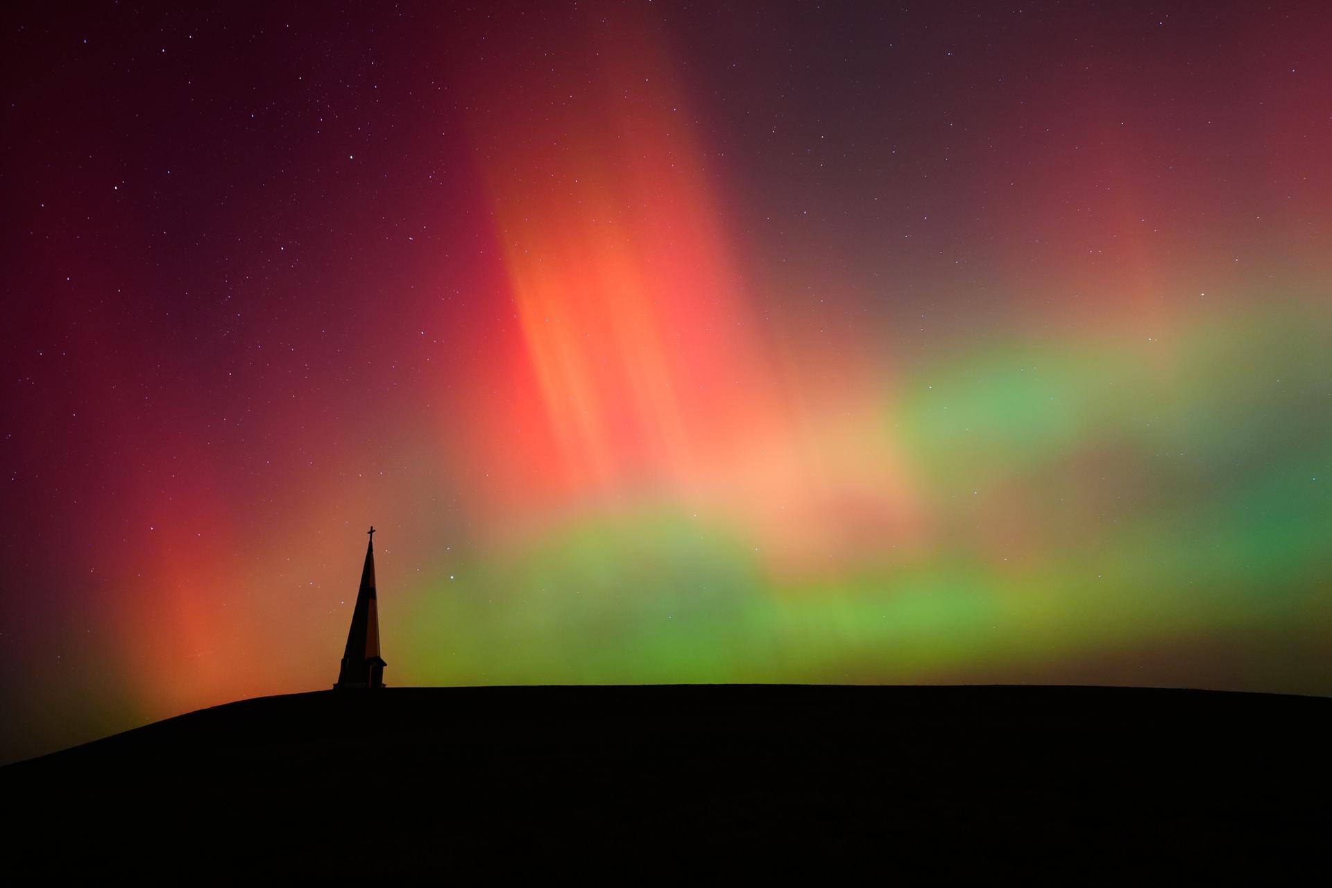 The northern lights fill the sky behind the Saint Joseph the Woodworker Shrine Tuesday, near Valley Falls, Kan.