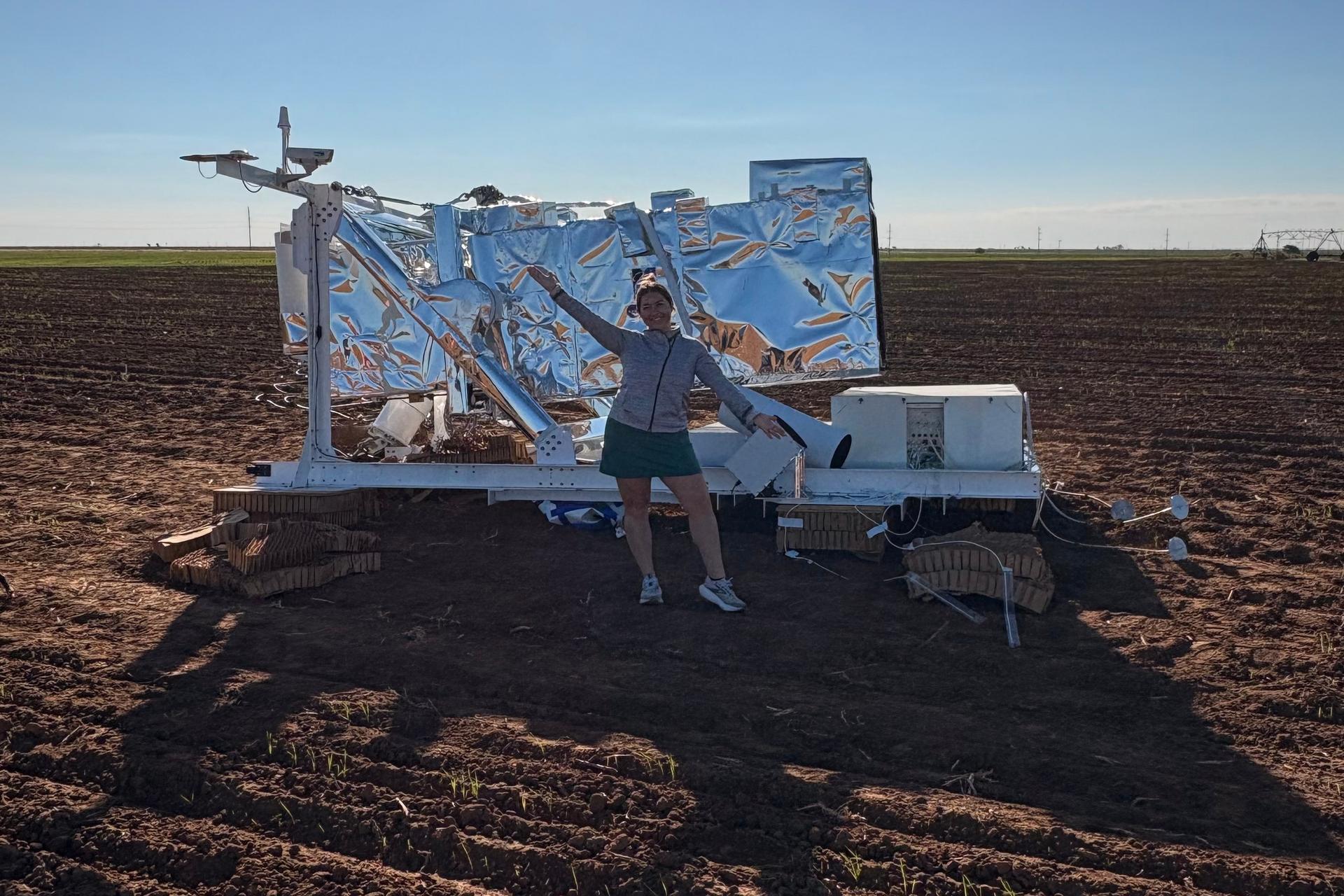 Ann Walter stands in front of a piece of NASA research equipment that fell from the sky near her home in Edmonson, Texas, on Oct. 2.