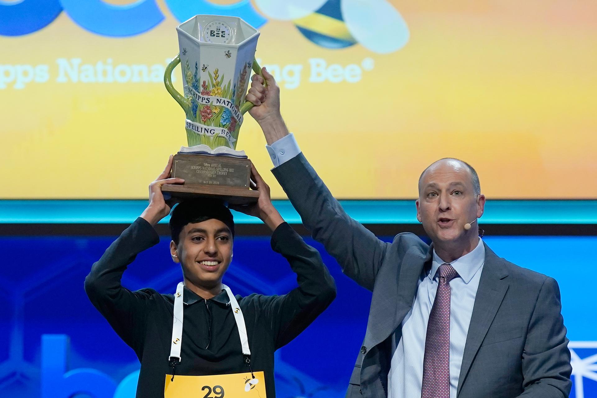 E.W. Scripps Company president and CEO Adam Symson, right, holds the trophy over winner of the 2026 Scripps National Spelling Bee, Shrey Parikh, 14, of Rancho Cucamonga, Calif., at DAR Constitution Hall, Thursday, in Washington. 