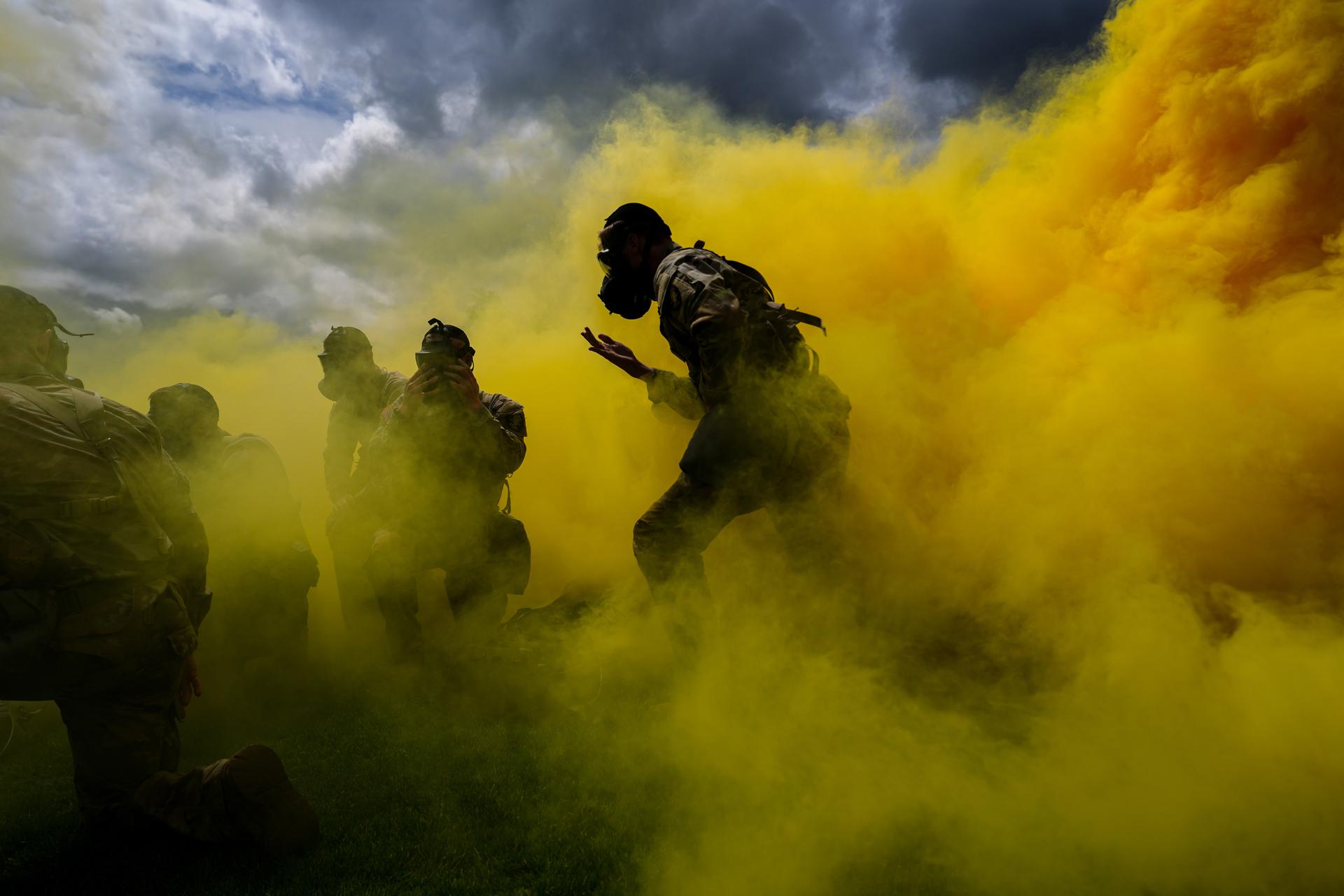 A West Point cadet dons a gas mask while running through smoke during the crucible portion of the Sandhurst Military Skills Competition at the United States Military Academy on Saturday. (AP Photo/Julia Demaree Nikhinson)