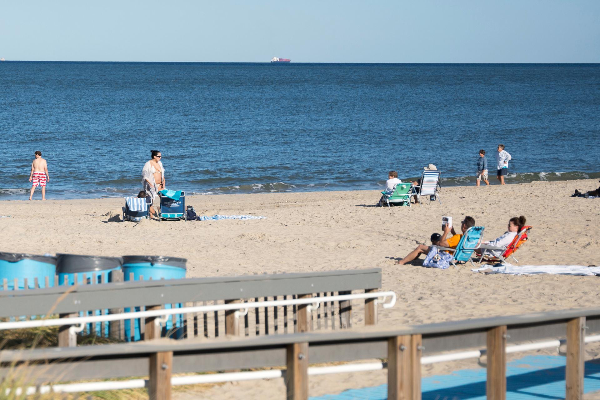 People relax at Rehoboth Beach, Del., on Wednesday. (AP Photo/Mingson Lau)