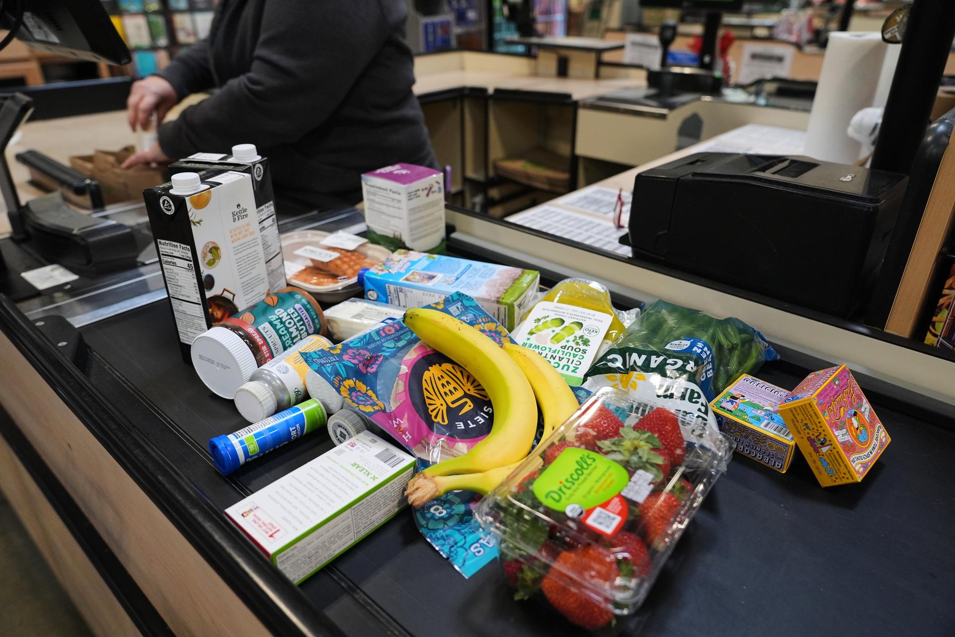 A cashier scans groceries at a grocery store in Baltimore on Monday. (AP Photo/Stephanie Scarbrough)