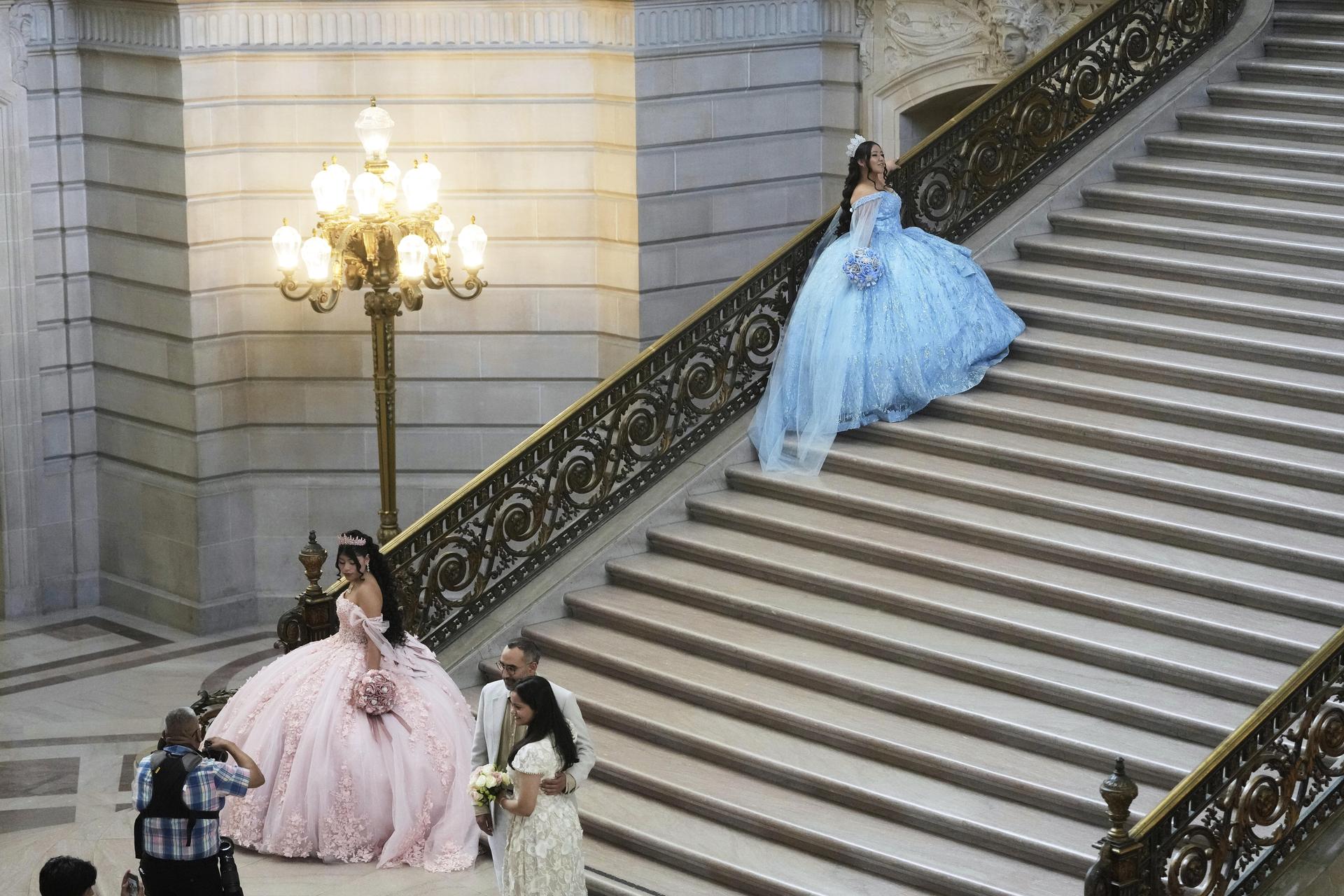 Abbie Gonzalez, top, poses in her quinceañera gown for her professional portrait session at City Hall in San Francisco, Monday, Aug. 25.