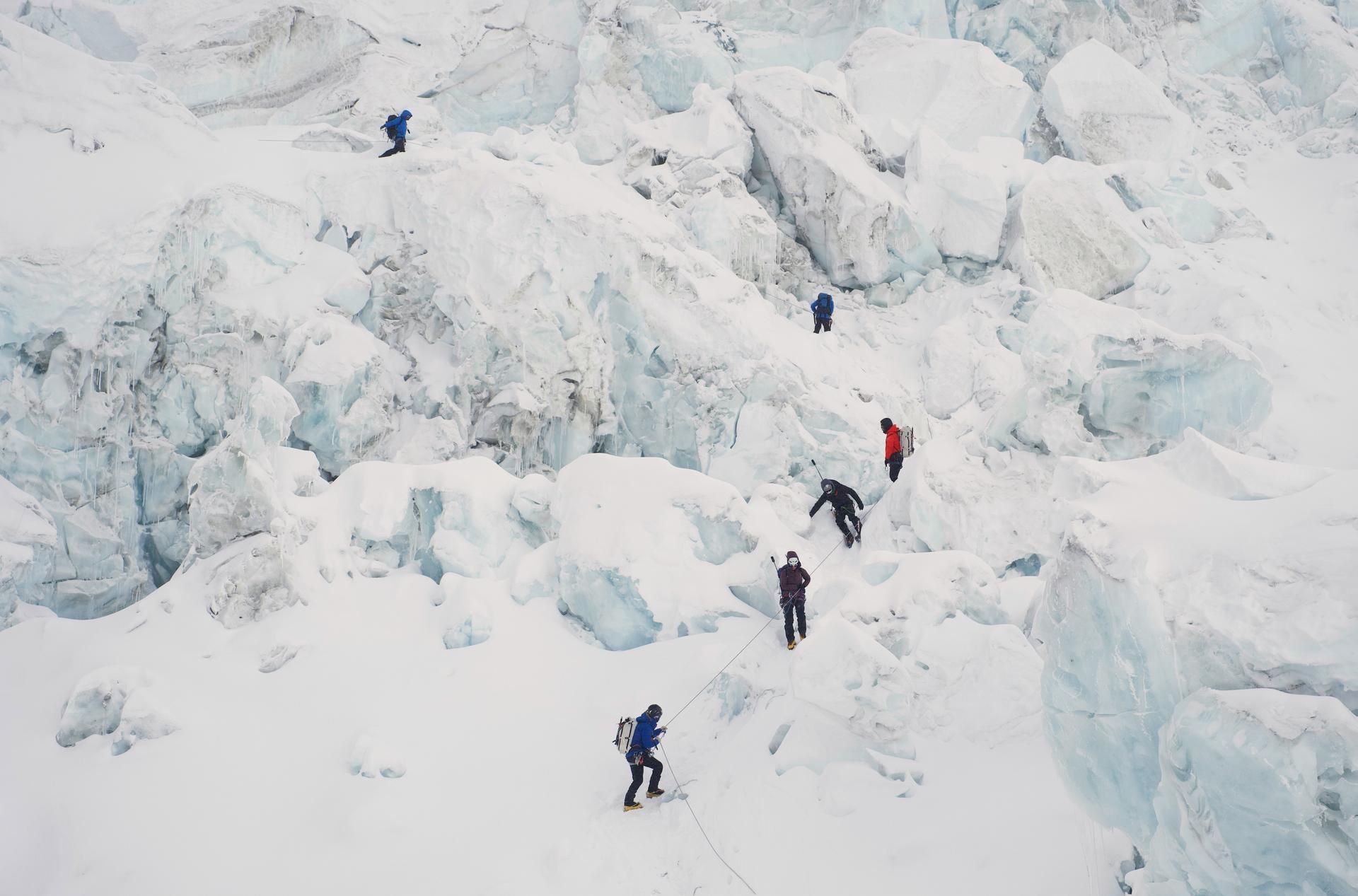 Mountaineers ascend Khumbu Icefall on their way to the summit of Mount Everest in Kathmandu, Nepal, on Saturday. (AP Photo/Pasang Rinzee Sherpa)