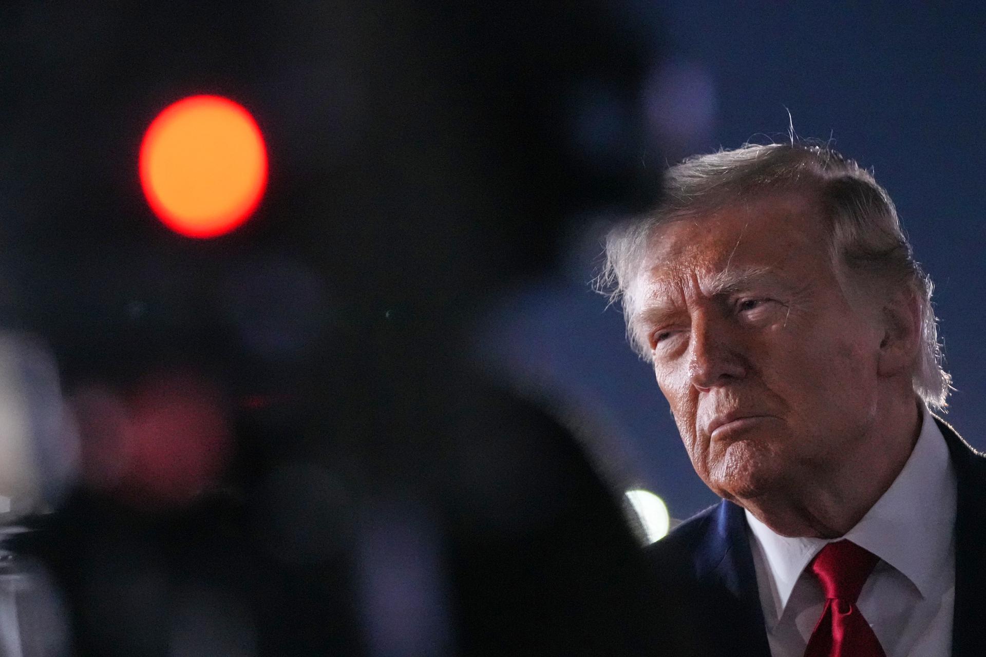 President Donald Trump talks with reporters before boarding Air Force One at John F. Kennedy International Airport in New York, Tuesday. 