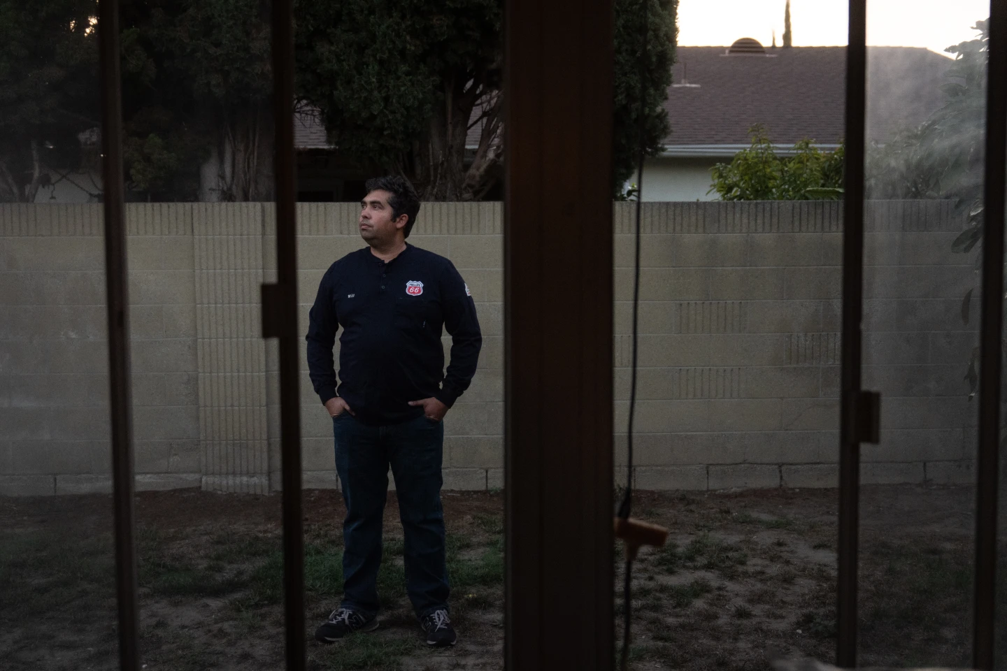 Wilfredo Cruz, an oil worker, stands for a photo in the backyard of his home on Sept. 30. (AP Photo/Jae C. Hong)