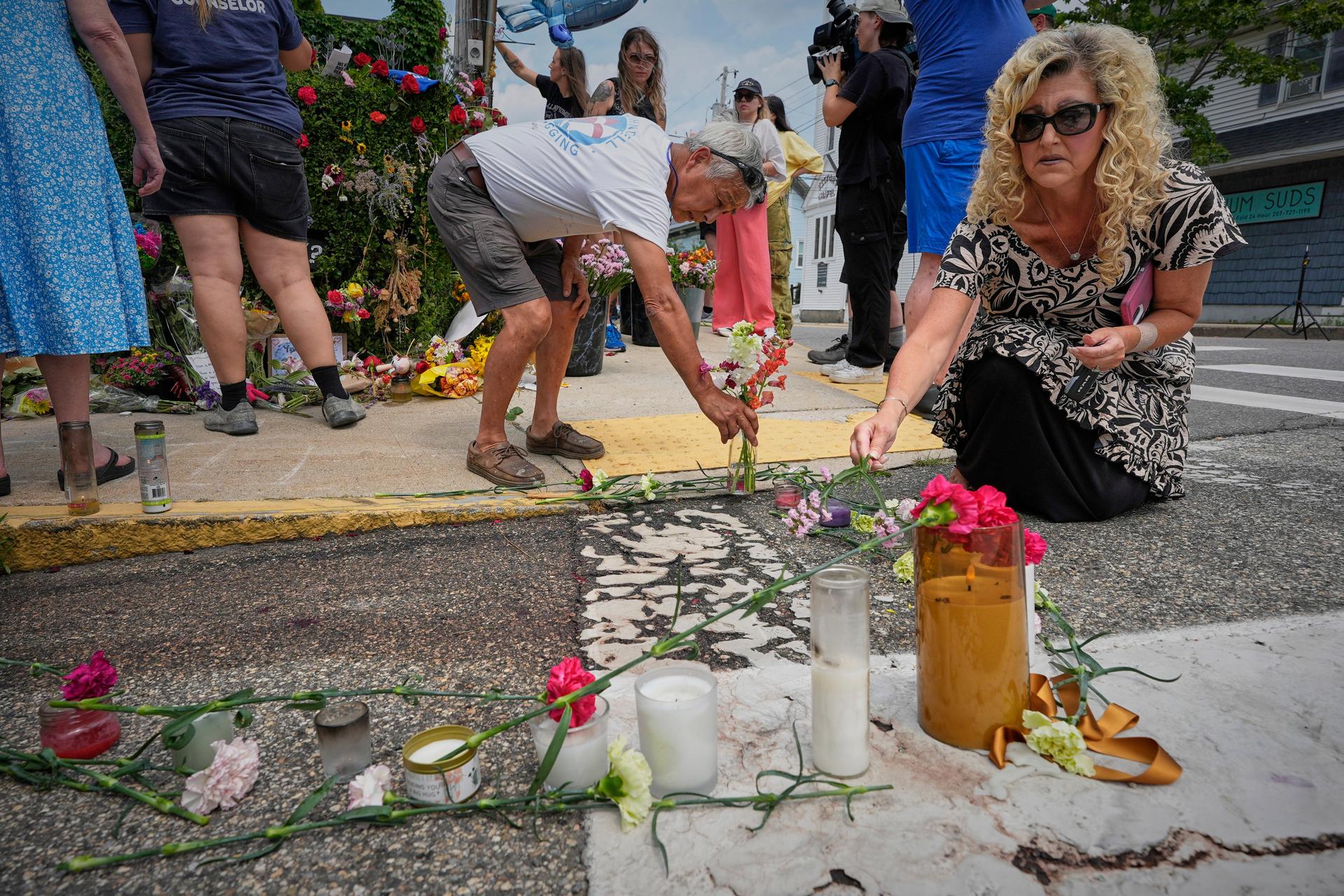 Mourners place flowers and candles in Biddeford, Maine, on Wednesday.