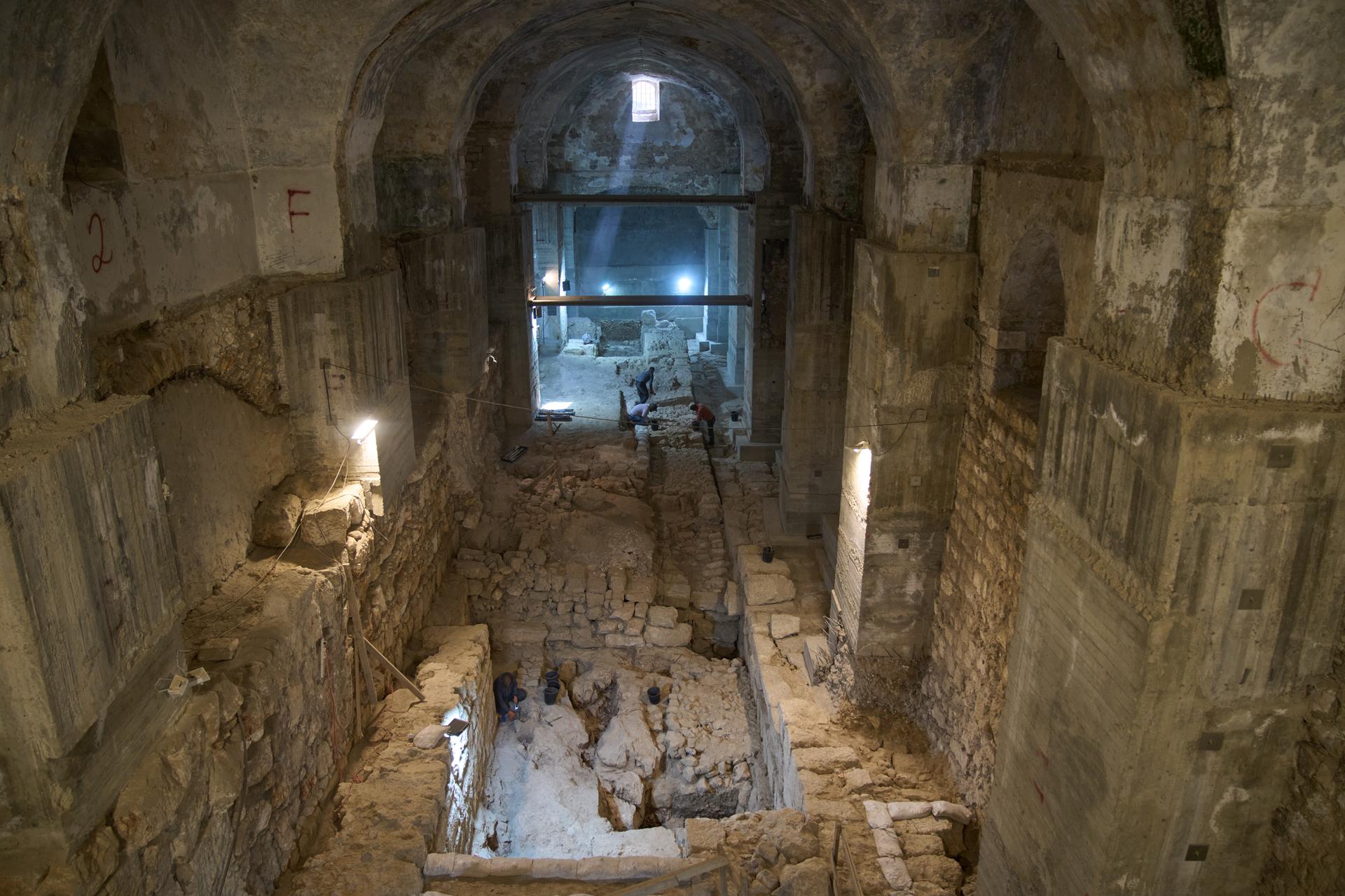 Workers from the Israel Antiquities Authority clean a section of an excavation site where, according to the institution, a city wall from the Hasmonean period, dating to the late 2nd century BCE, was uncovered under the Tower of David Citadel Museum, in the Old City of Jerusalem, Monday.