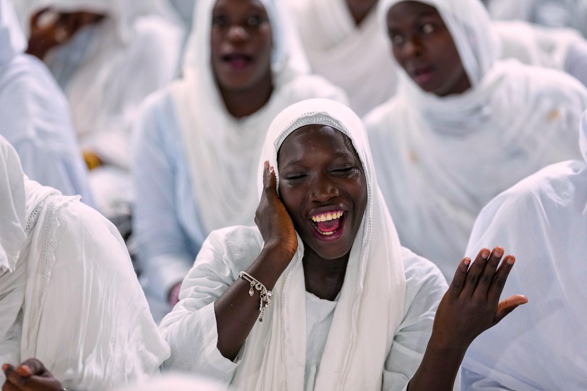 A woman recites prayers as people mark Prophet Muhammad's birthday in Dakar, Senegal, in September. (AP Photo/Misper Apawu)