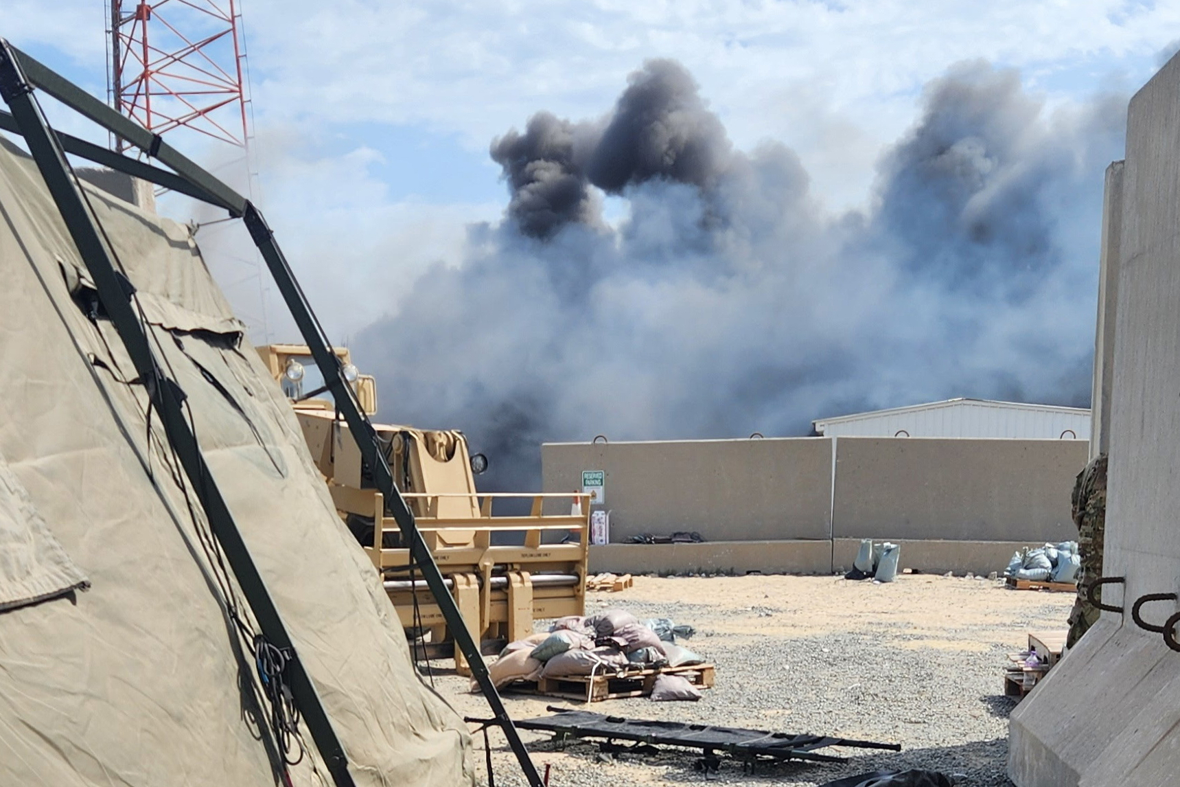 In this photo obtained by The Associated Press, smoke rises from an Iranian drone strike at Port Shuaiba in Kuwait on March 1, 2026, which killed multiple U.S. soldiers and injured dozens more. 