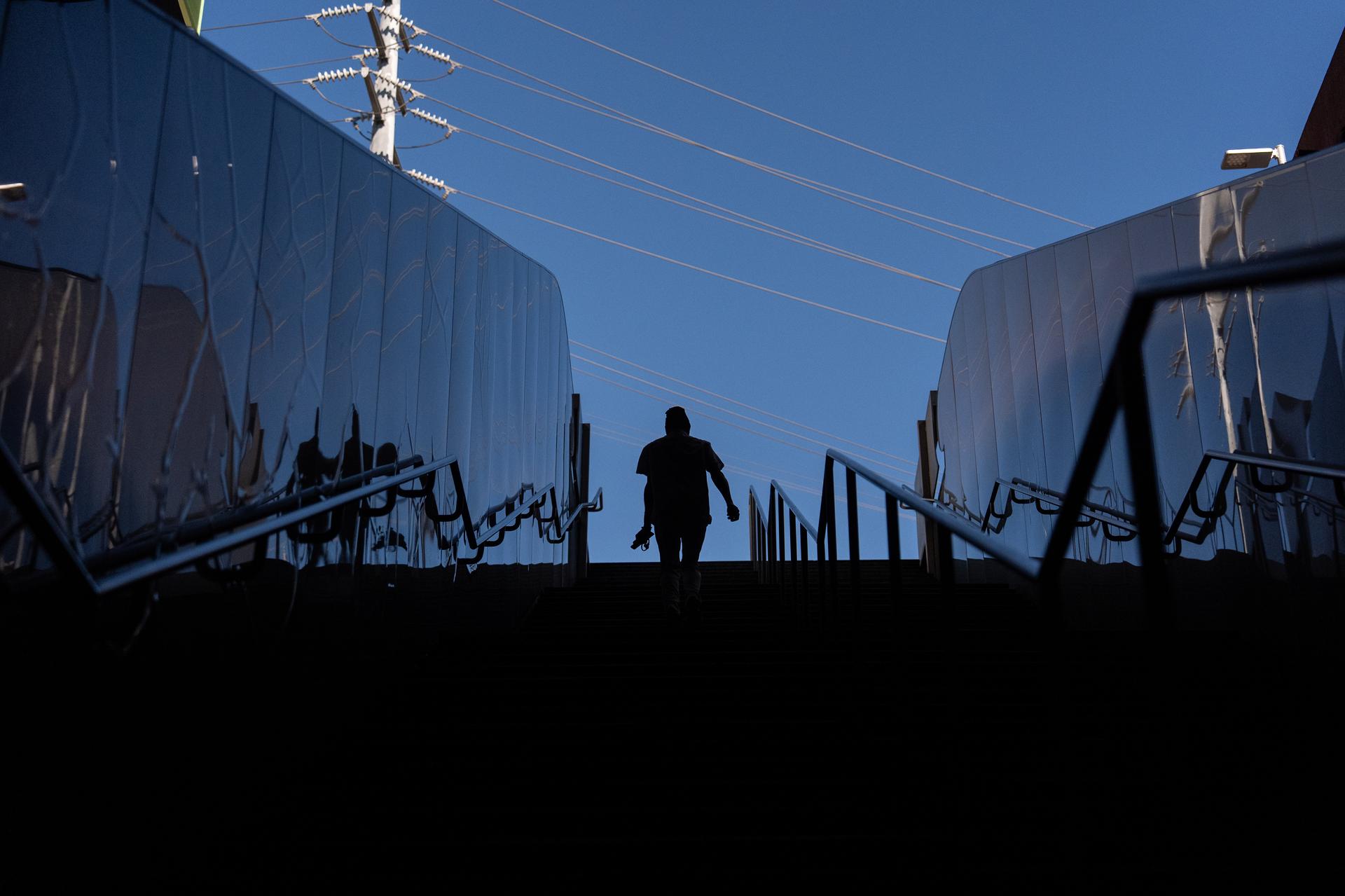 Quantavia Smith walks up the steps of a metro station next to the Santa Monica and Vermont Apartments in Los Angeles on Monday. (AP Photo/Jae C. Hong)