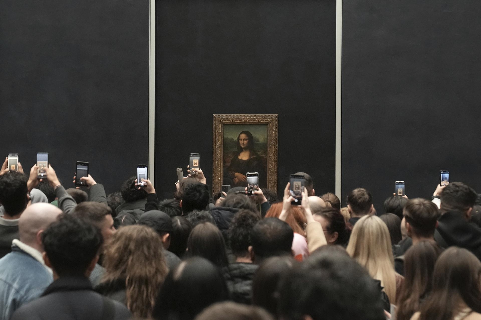 Visitors take photographs of Leonardo da Vinci's painting of the Mona Lisa, at the Louvre museum, Jan. 27, in Paris