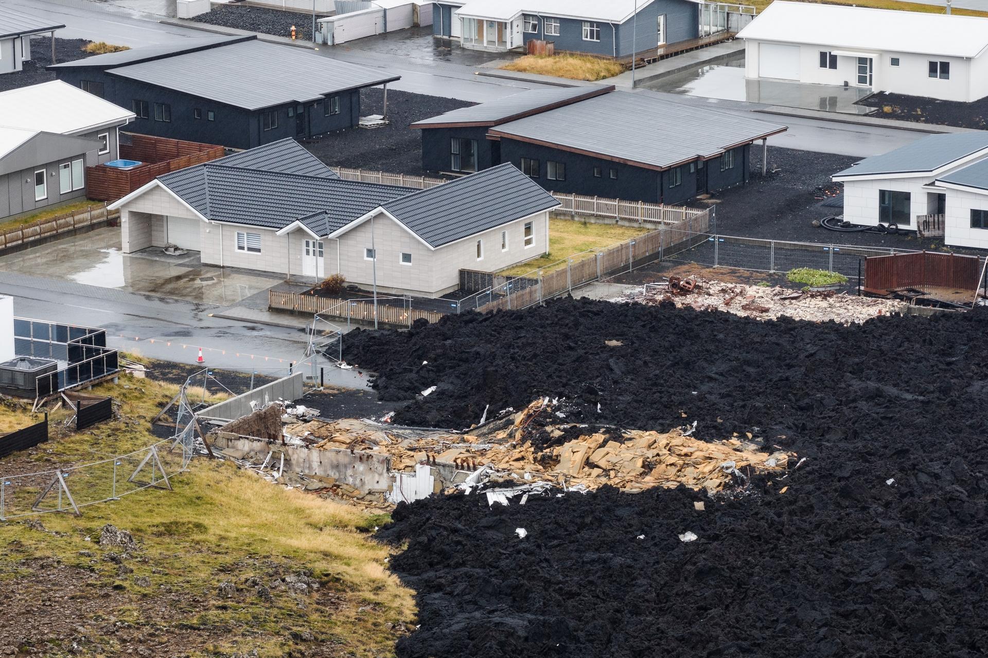 A house, destroyed by lava, is visible on the edge of a hardened flow in Grindavik, Iceland, on Friday. (AP Photo/Marco di Marco)