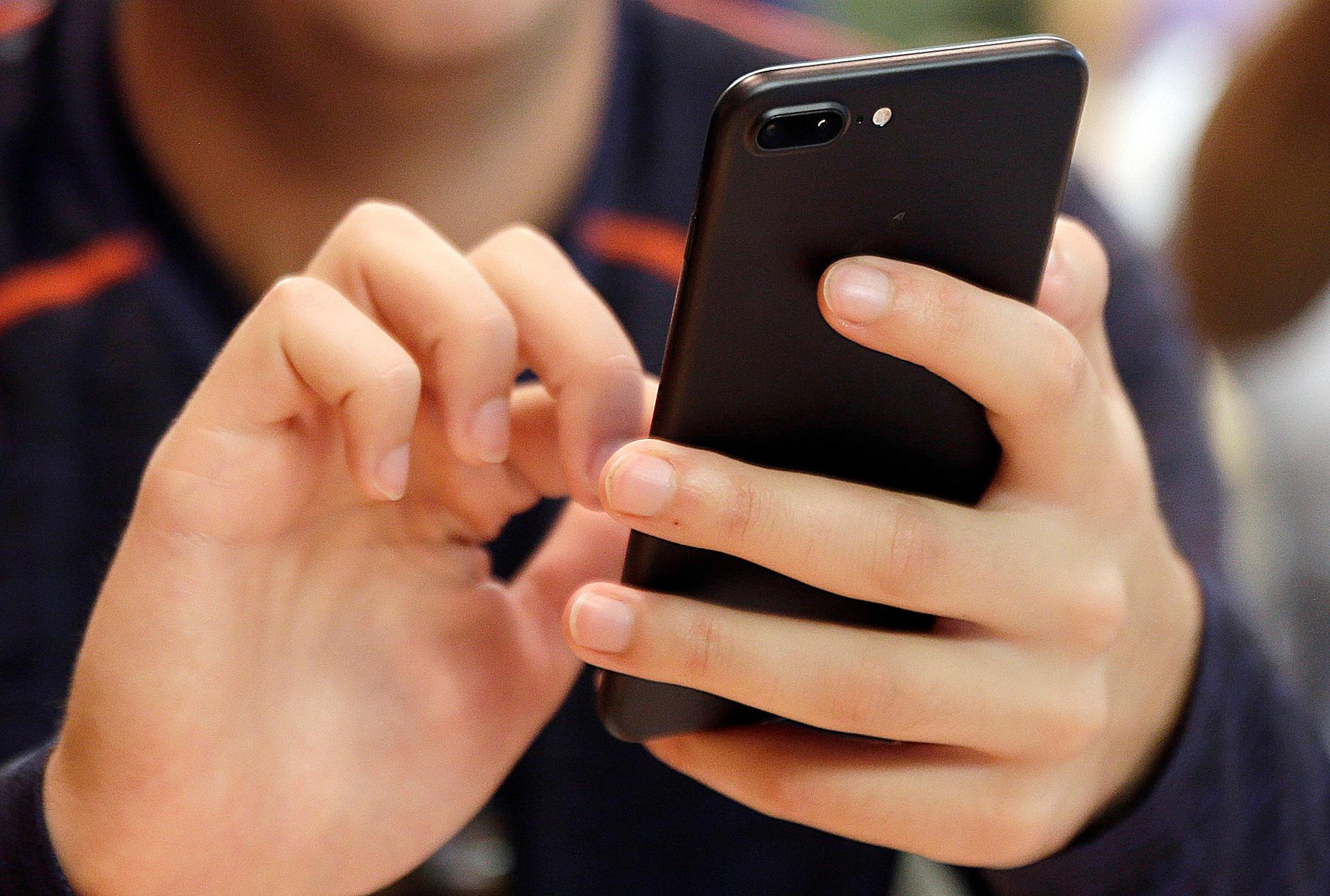 A person uses a smartphone in Chicago, 2017.