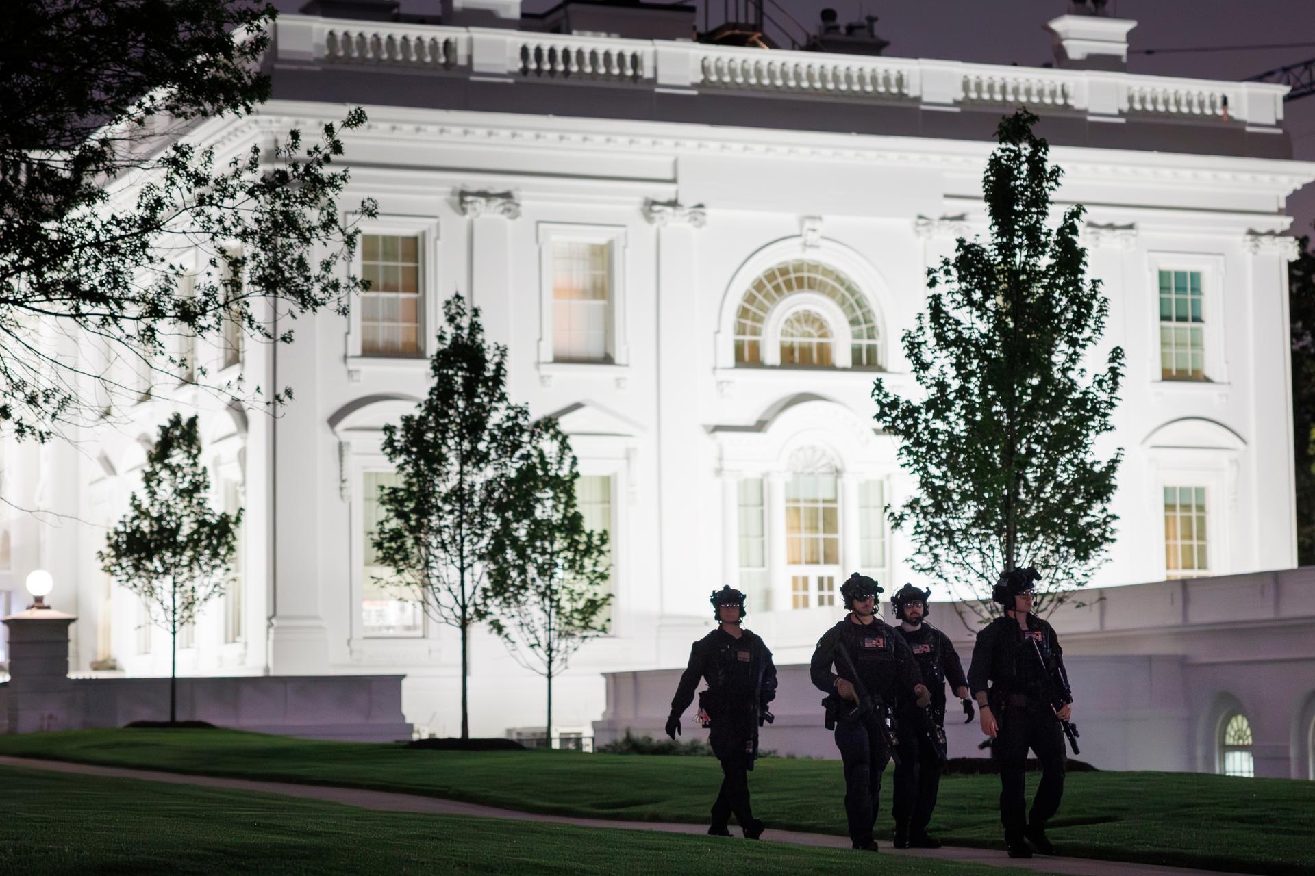 U.S. Secret Service agents patrol the North Lawn at the White House after a shooting incident outside the ballroom at the annual White House Correspondents’ Association Dinner in Washington, Saturday.