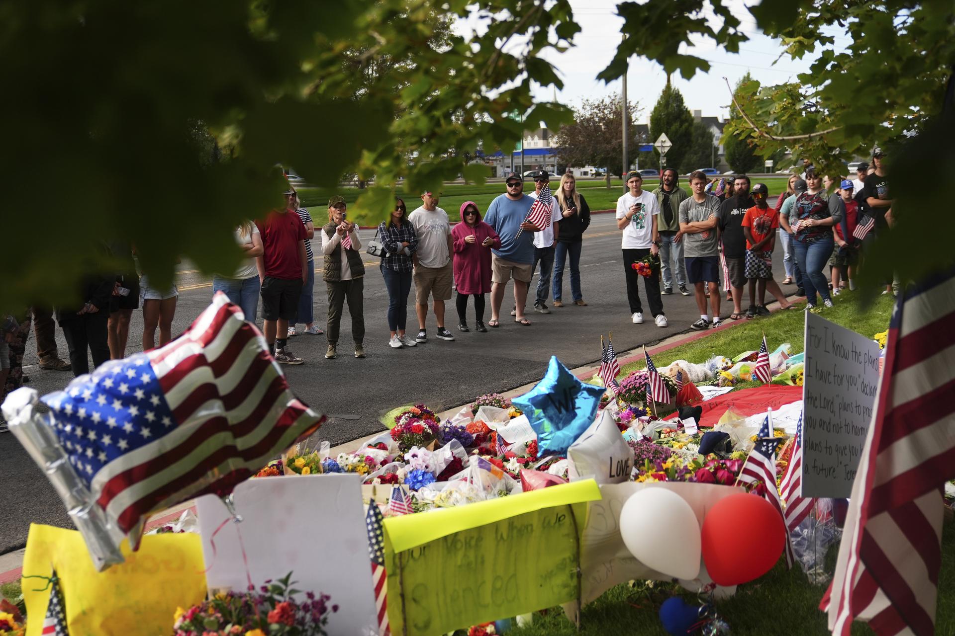 Supporters gather at a makeshift memorial for Turning Point USA CEO and co-founder Charlie Kirk in Orem, Utah, on Saturday. (AP Photo/Lindsey Wasson)