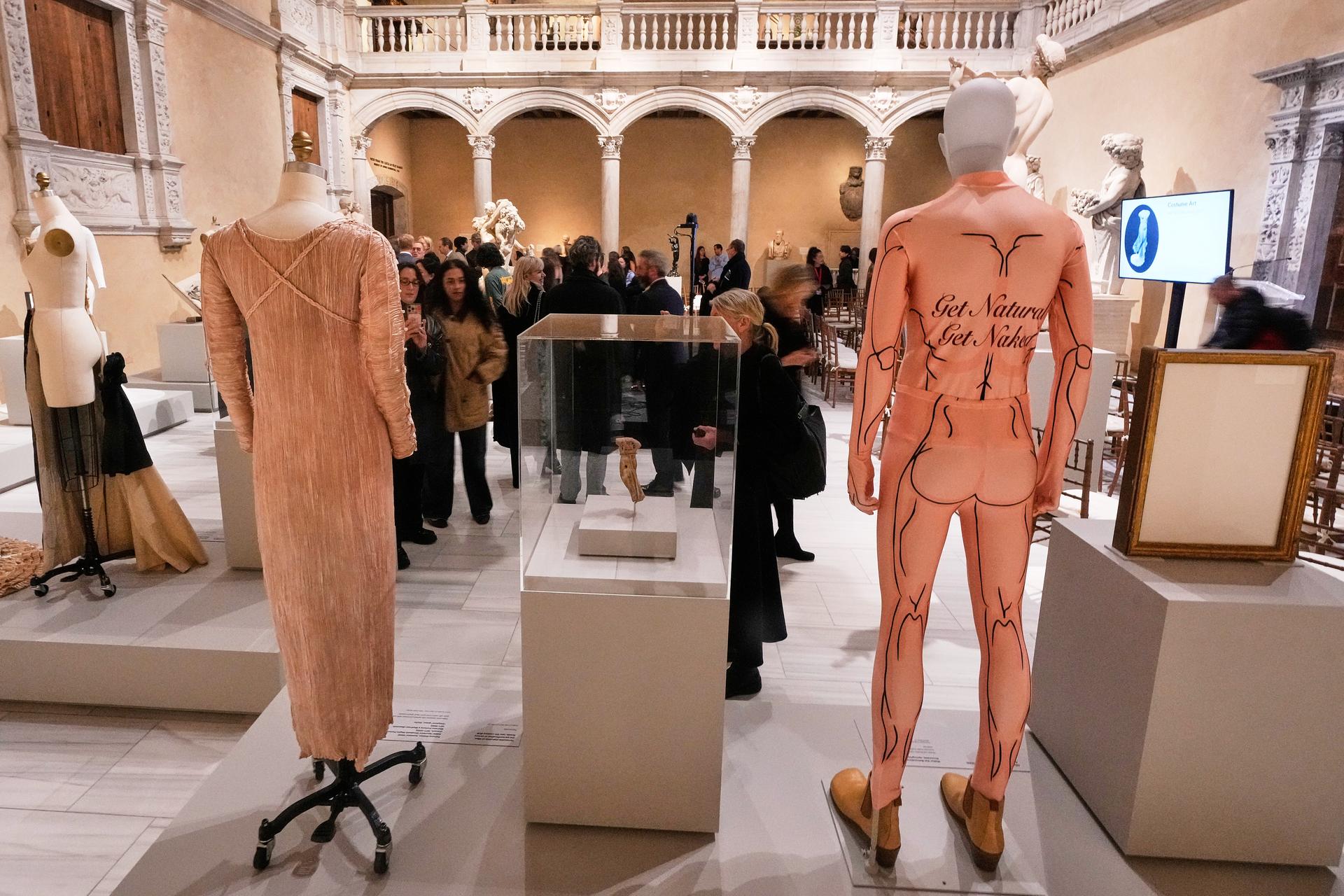 A spandex bodysuit by Belgian designer Walter Van Beirendonck from a 2009 collection, right, is displayed during the announcement, at the Metropolitan Museum of Art, in New York, Monday, about the next spring fashion exhibit 