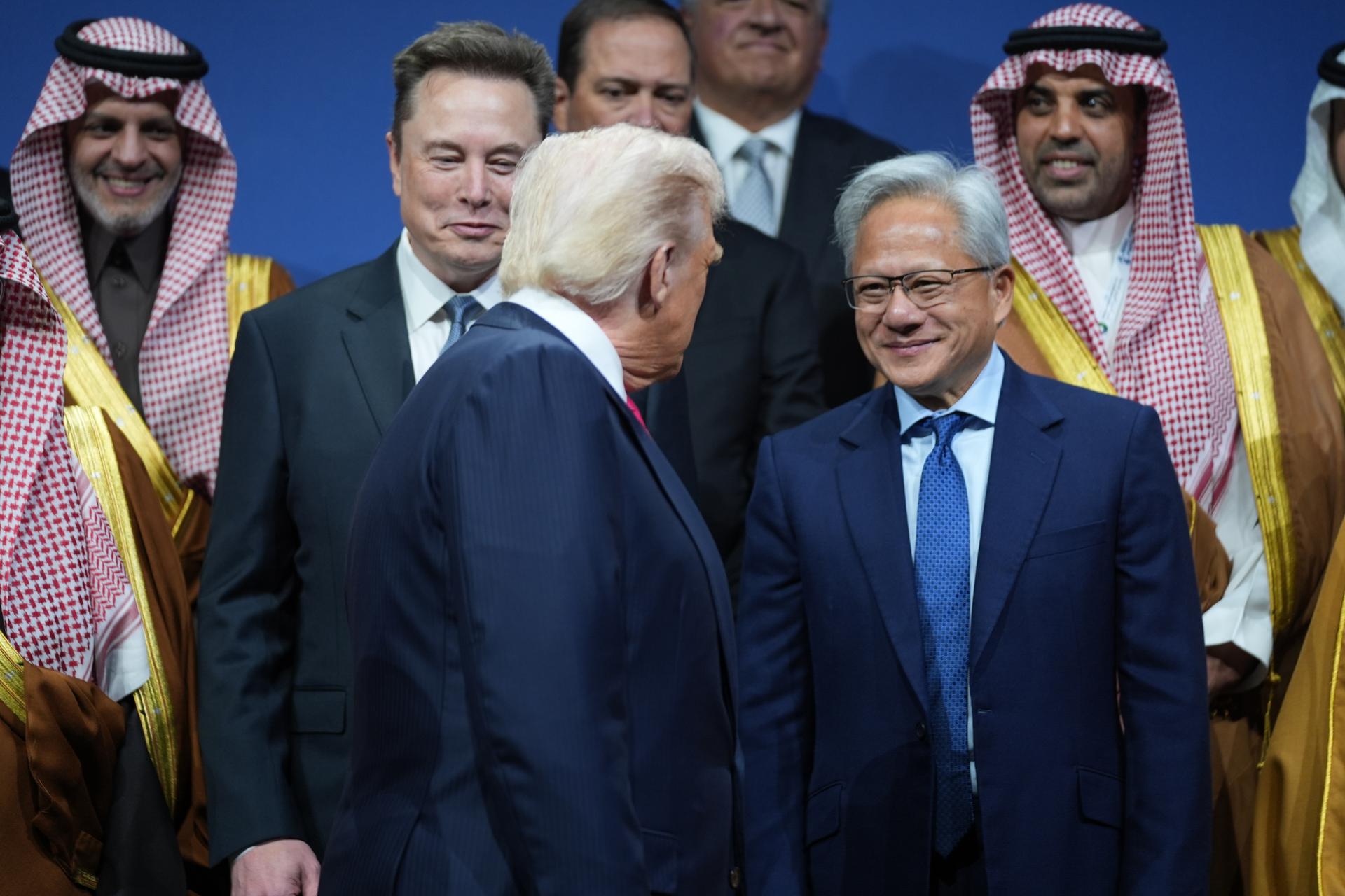 President Donald Trump speaks with Elon Musk and Nvidia CEO Jensen Huang, during the Saudi Investment Forum at the Kennedy Center, Nov. 19, 2025, in Washington. (AP Photo/Evan Vucci)