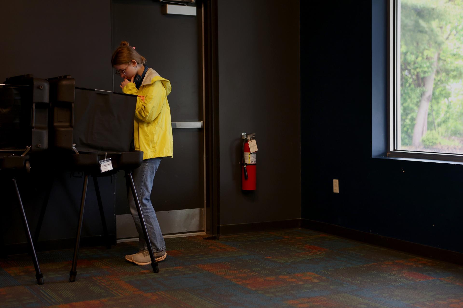 First-time voter Frida Webb casts a ballot in a polling location during a primary election on Tuesday in West Lafayette, Ind.