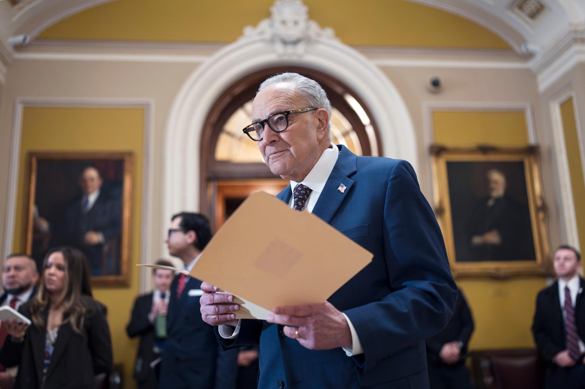 Senate Minority Leader Chuck Schumer, D-N.Y., waits to speak to reporters following a closed-door meeting with fellow Democrats on spending legislation, at the Capitol in Washington, Wednesday.