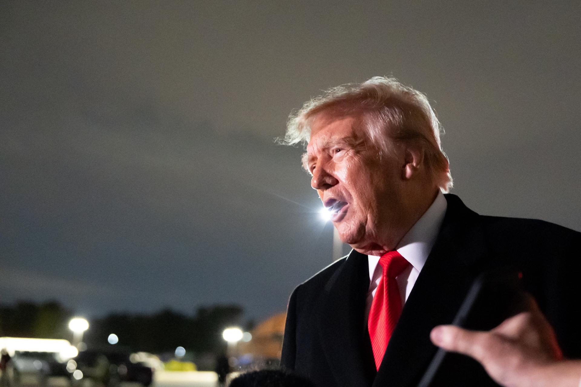 President Donald Trump speaks with reporters as he arrives on Air Force One, Saturday, at Joint Base Andrews, Md.