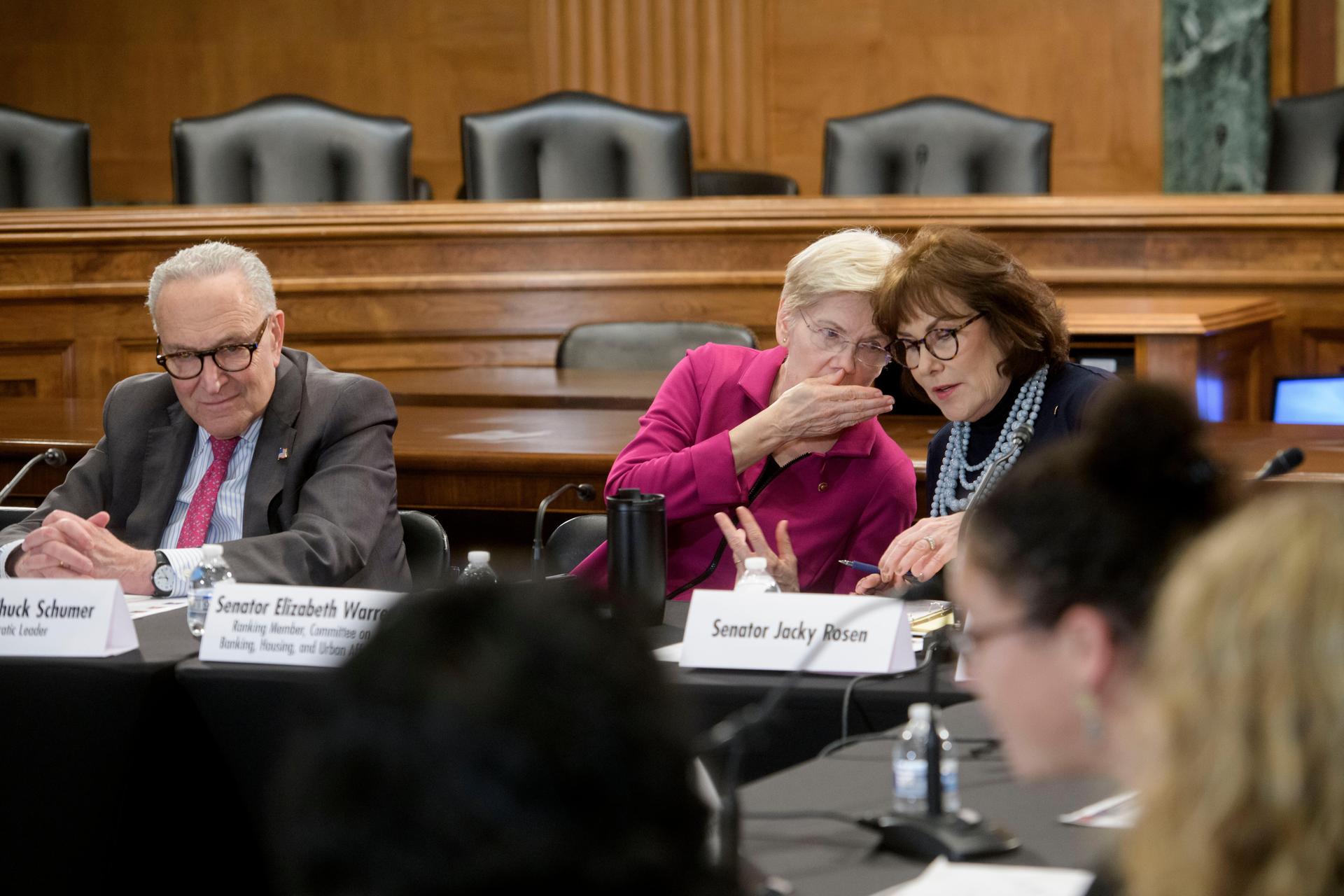 Senate Minority Leader Charles Schumer, D-N.Y., left, sits at left as Sen. Elizabeth Warren, D-Mass., center, talks with Sen. Jacky Rosen, D-Nev., during a round table discussion on the high cost of housing, on Capitol Hill, Jan. 7, 2026, in Washington.