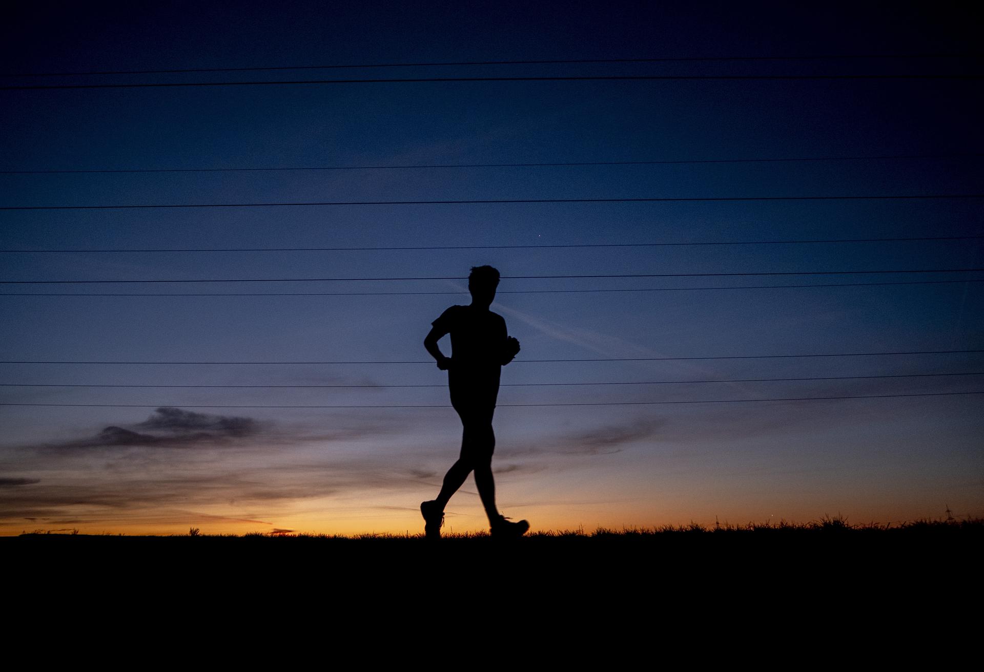A man runs on the outskirts of Frankfurt, Germany, before sunrise in 2020. 