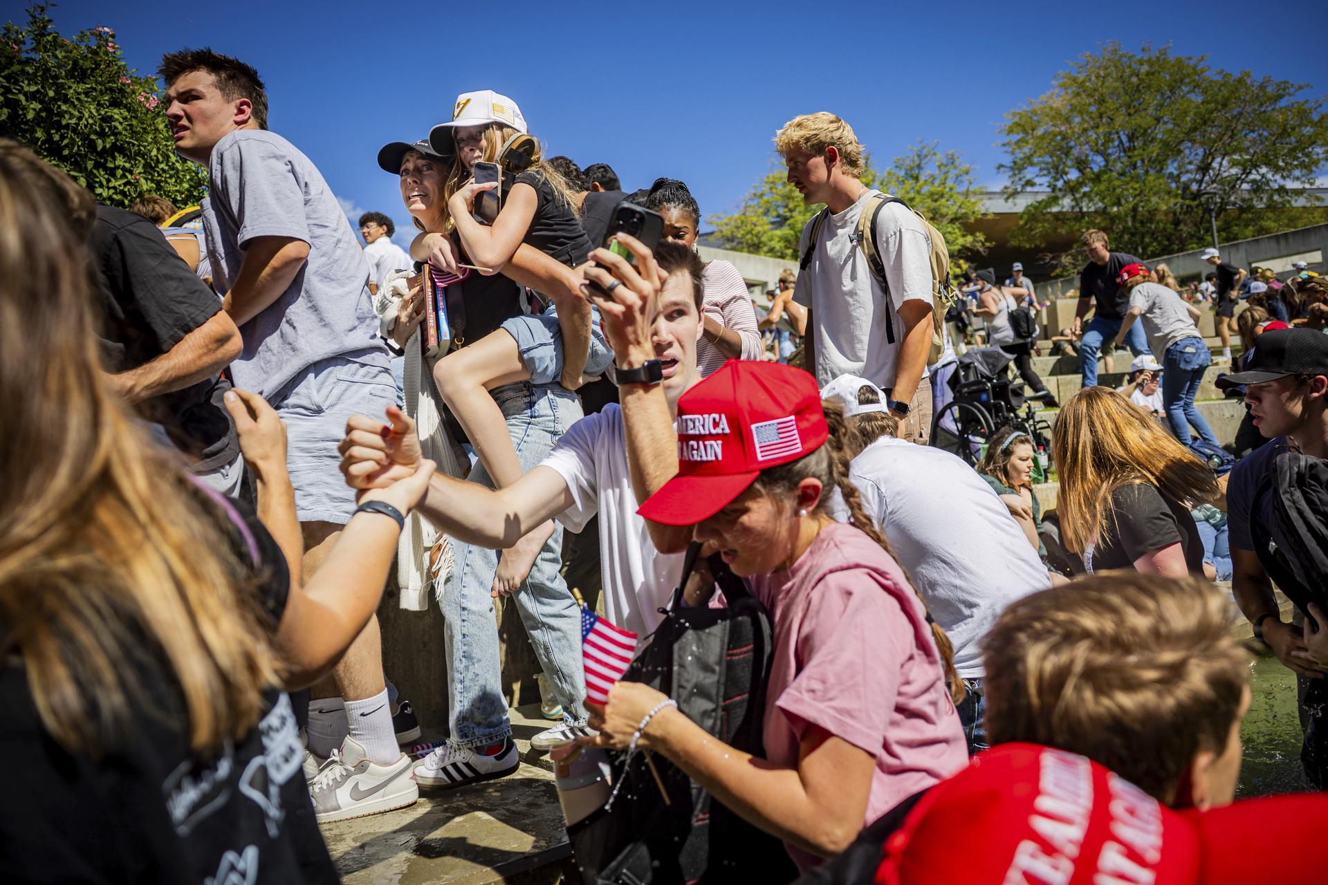 The crowd reacts after Charlie Kirk is shot at the Utah Valley University on Wednesday. (Tess Crowley/The Deseret News via AP)