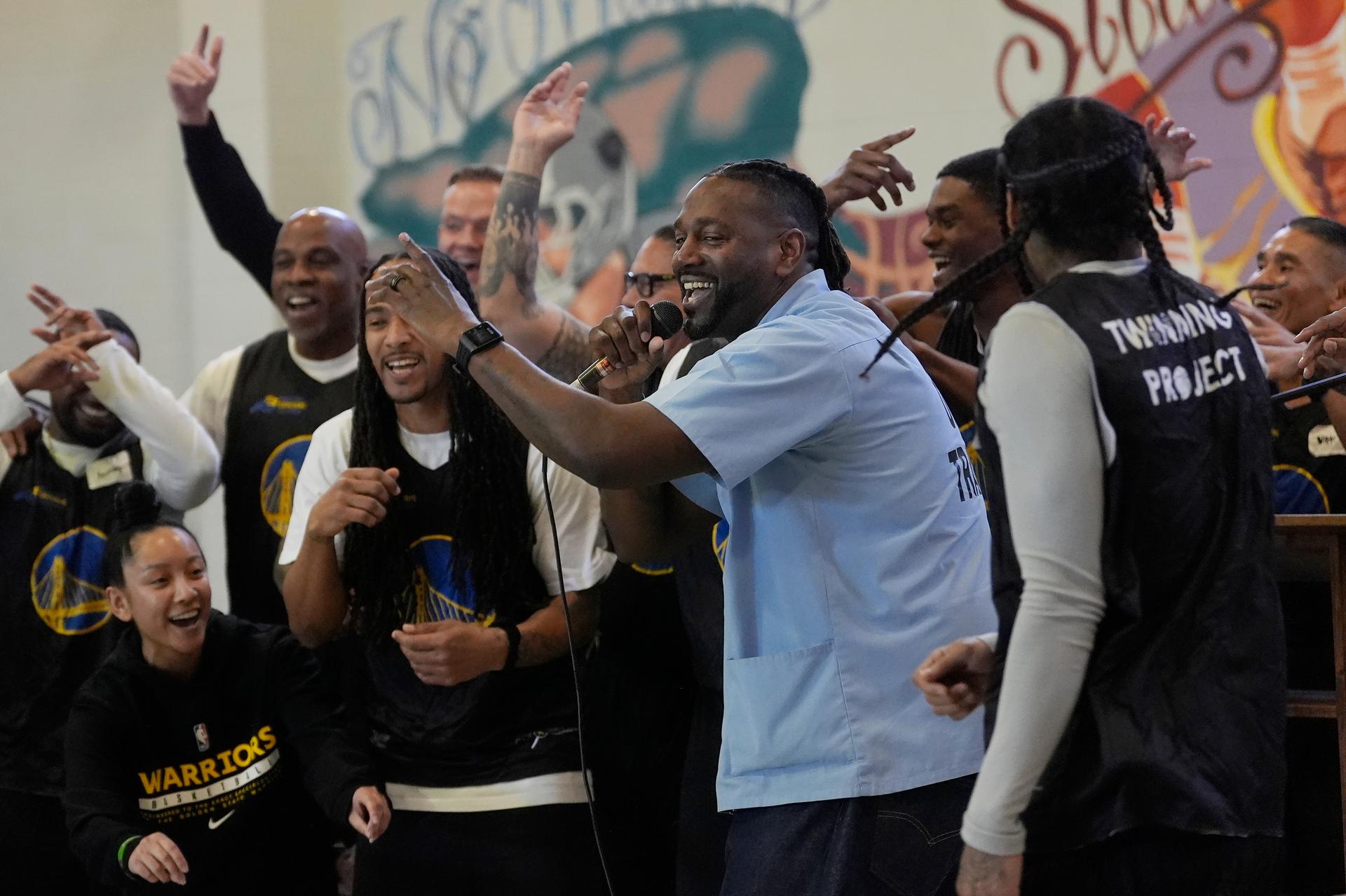 Ray Woodfork, a graduate of Twinning Project's collaboration performs a song in front of cohort 2 participants and Warriors Basketball Academy members at Solano State Prison in Vacaville, Calif., in February. 