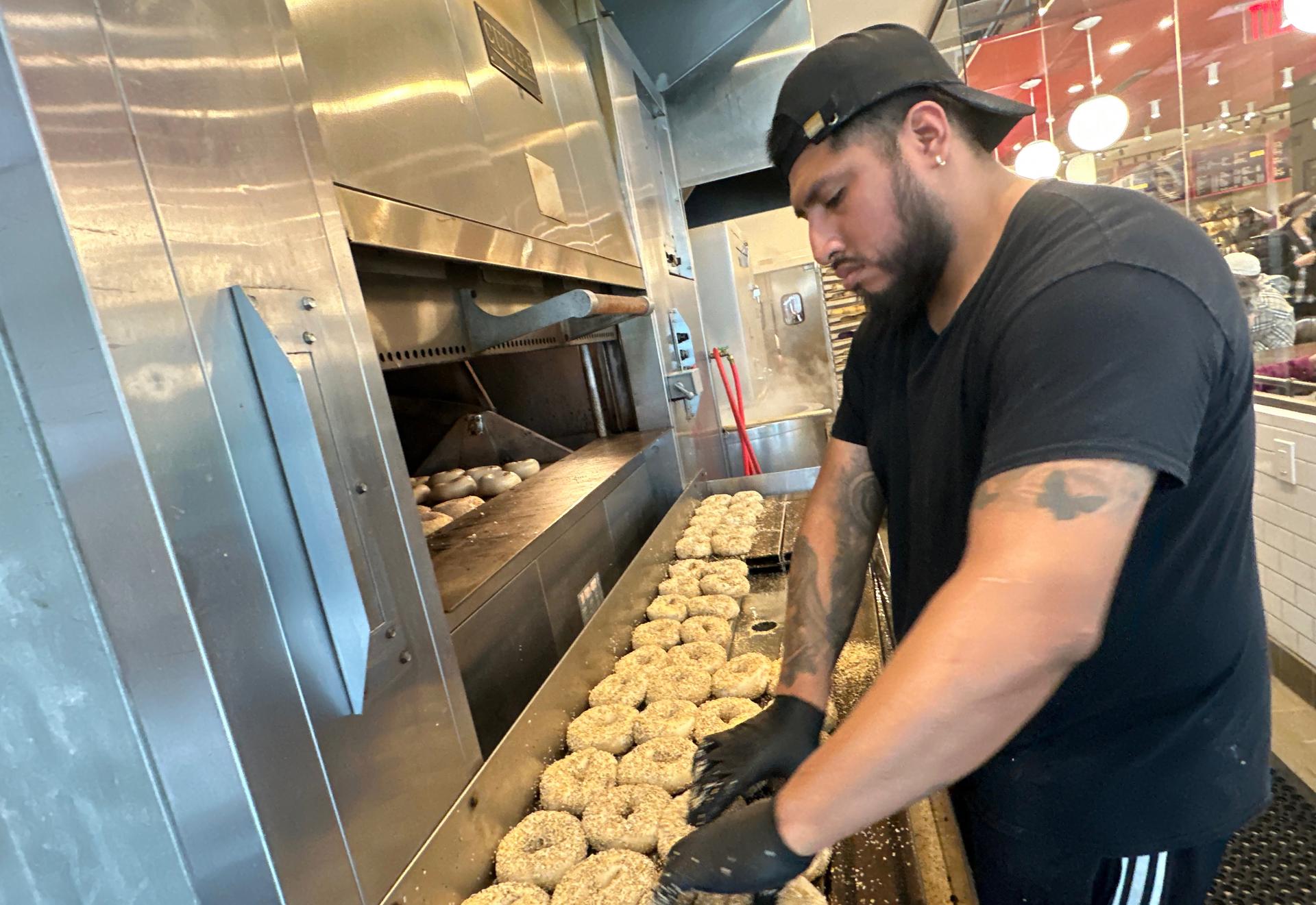 A worker at Utopia Bagel preps bagels made with bromated flour, May 13, in the Queens borough of New York.