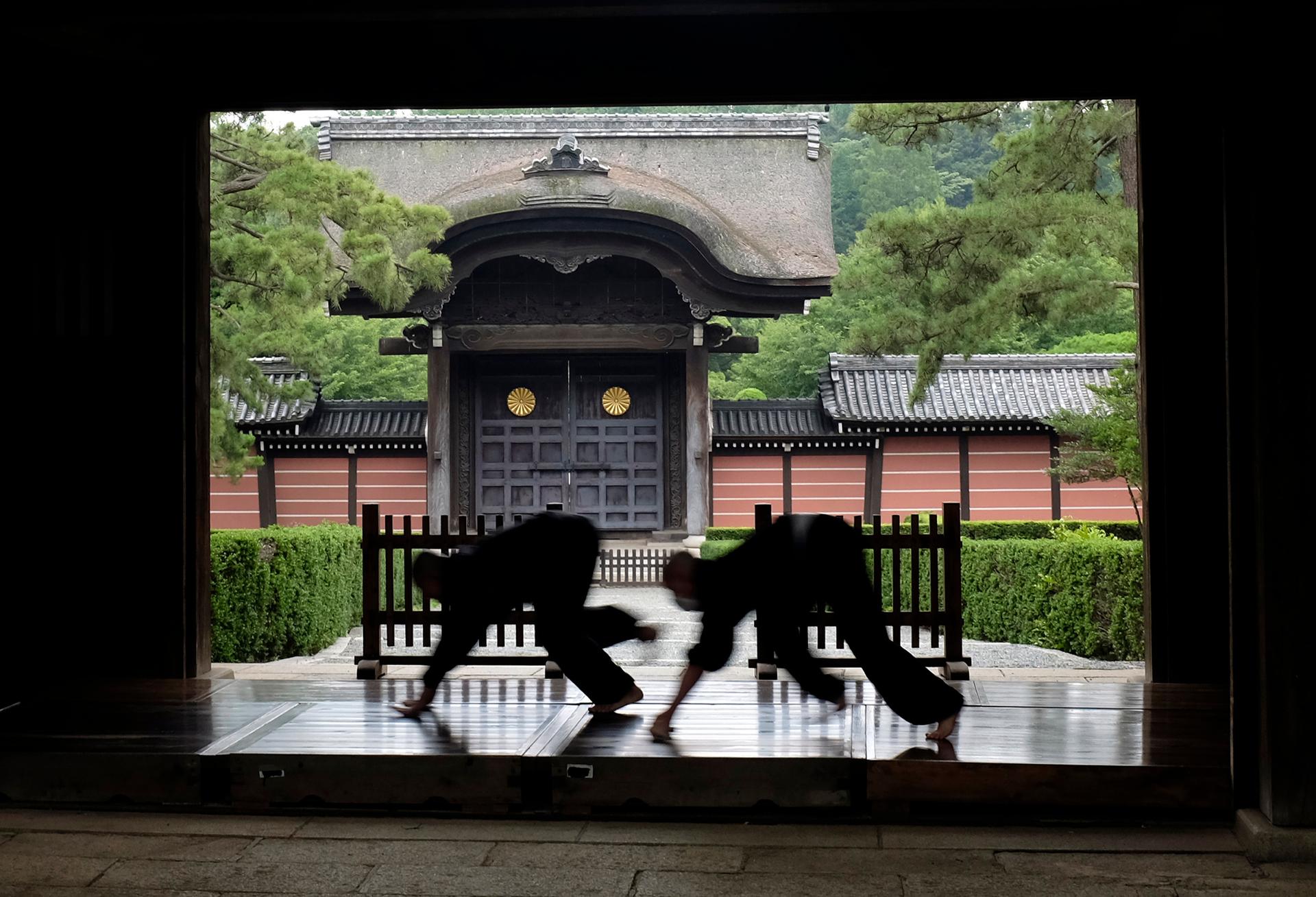 Monks polish the wooden corridor of the walkway that connects between temple buildings at Soji-ji in Yokohama, Japan, 2016. 
