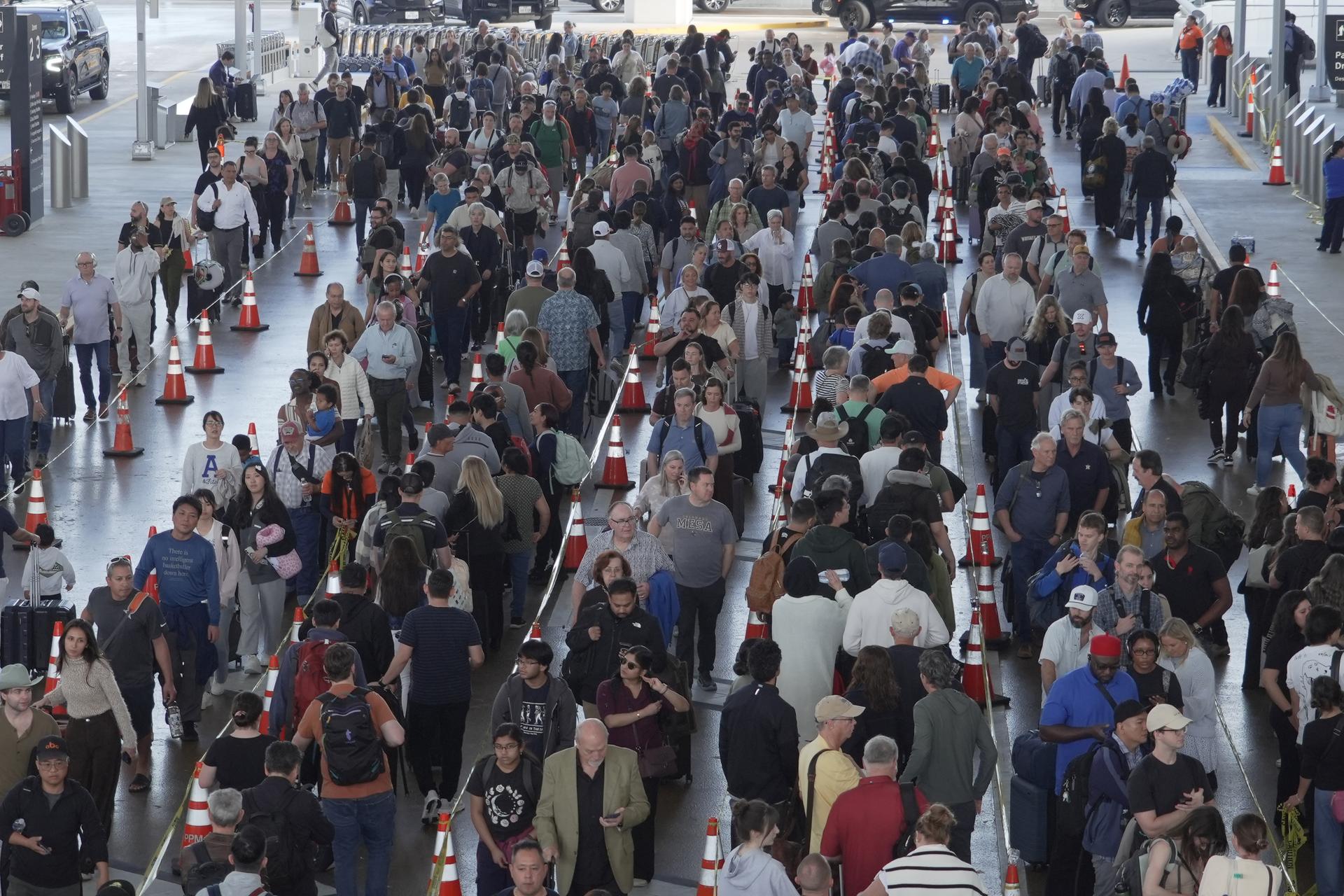 Travelers line up at a TSA checkpoint at George Bush Intercontinental Airport in Houston on Thursday.