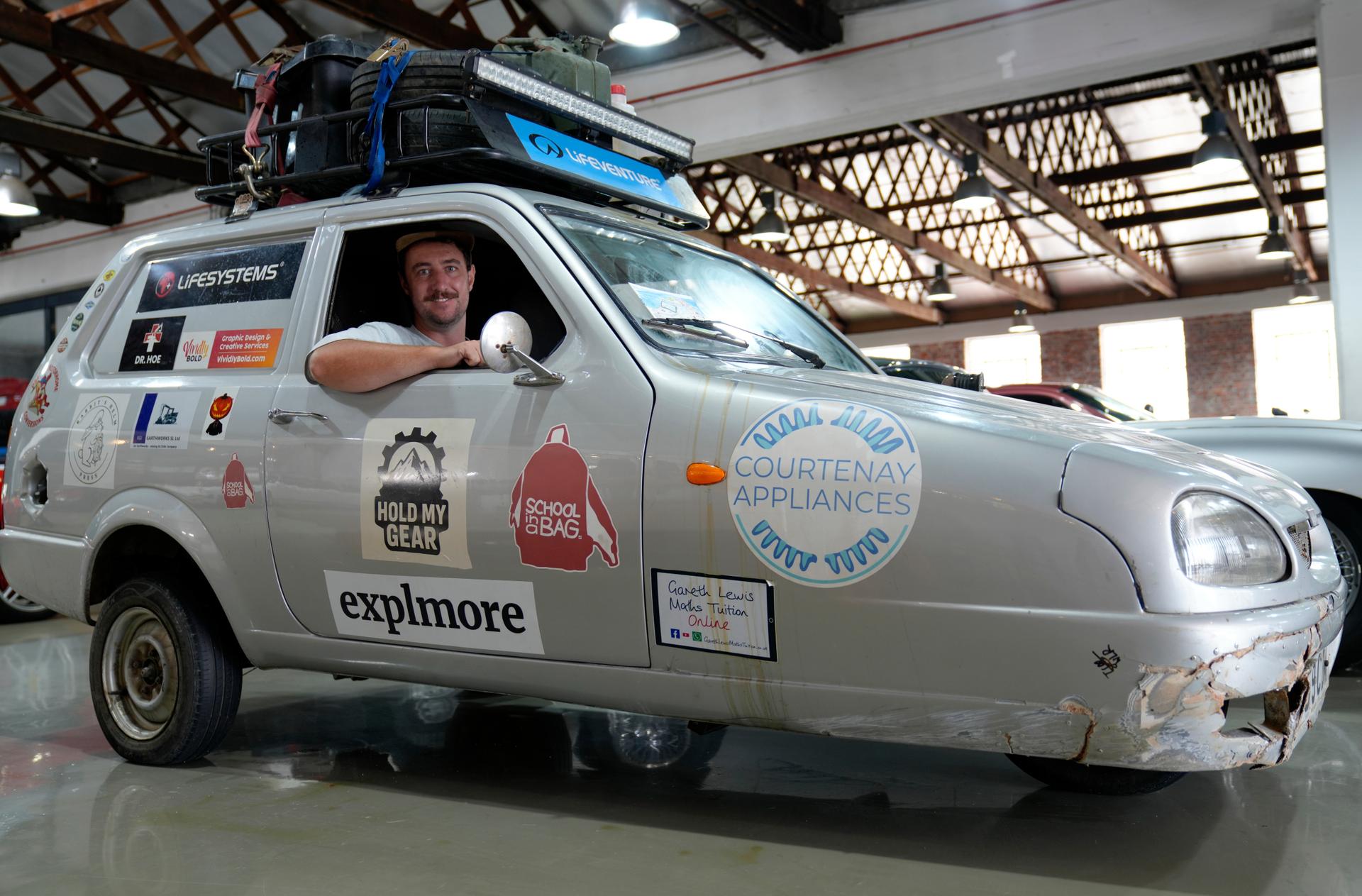 Oliver Jenks poses with the Reliant Robin called “Sheila the three-wheeler” that he and Seth Scott drove from London to Cape Town in a bid to break a Guinness World Record, in Cape Town, South Africa, March 20. 