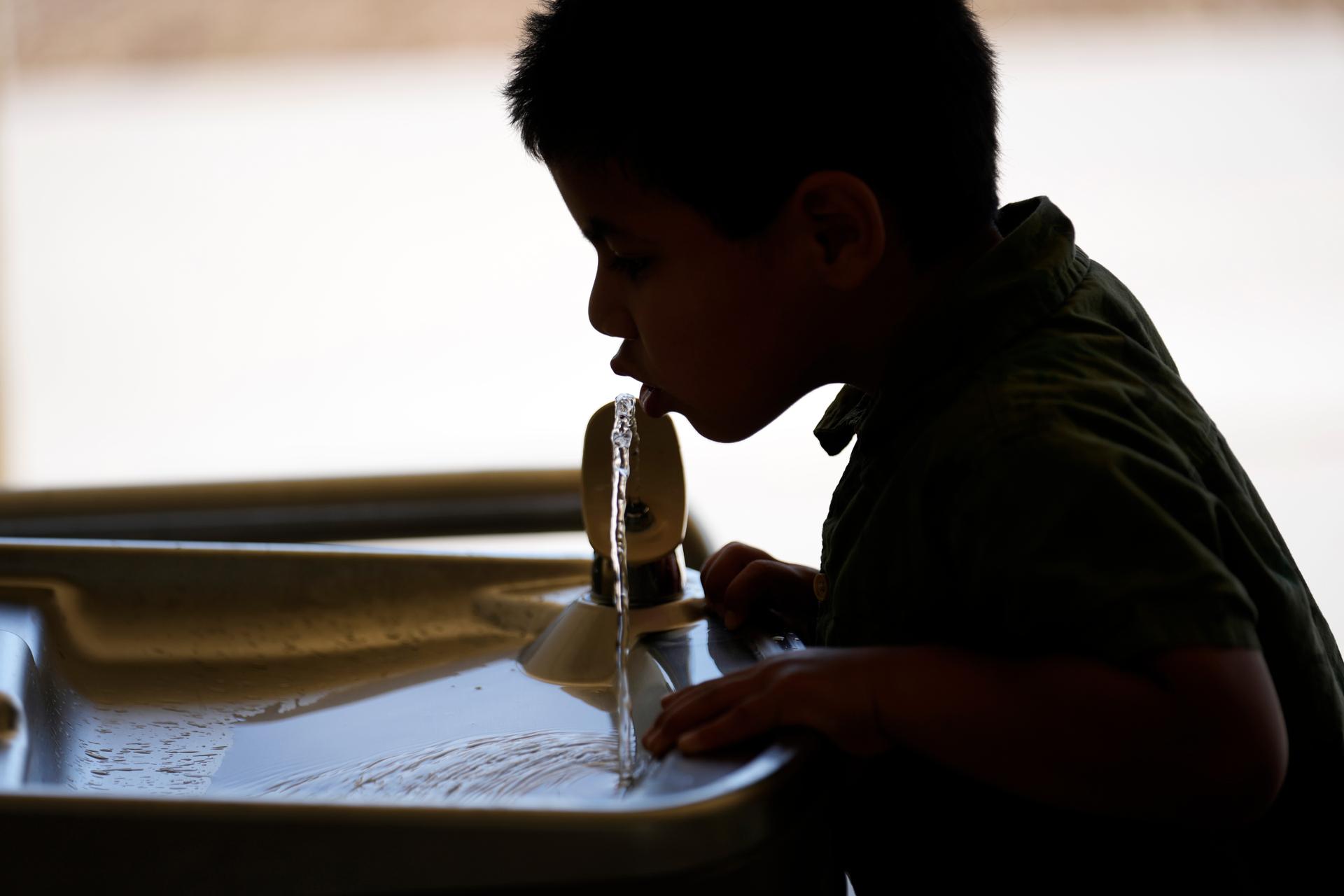 A student drinks from a water fountain inside Cuyama Elementary School in New Cuyama, Calif. in 2023. (AP Photo/Marcio Jose Sanchez)