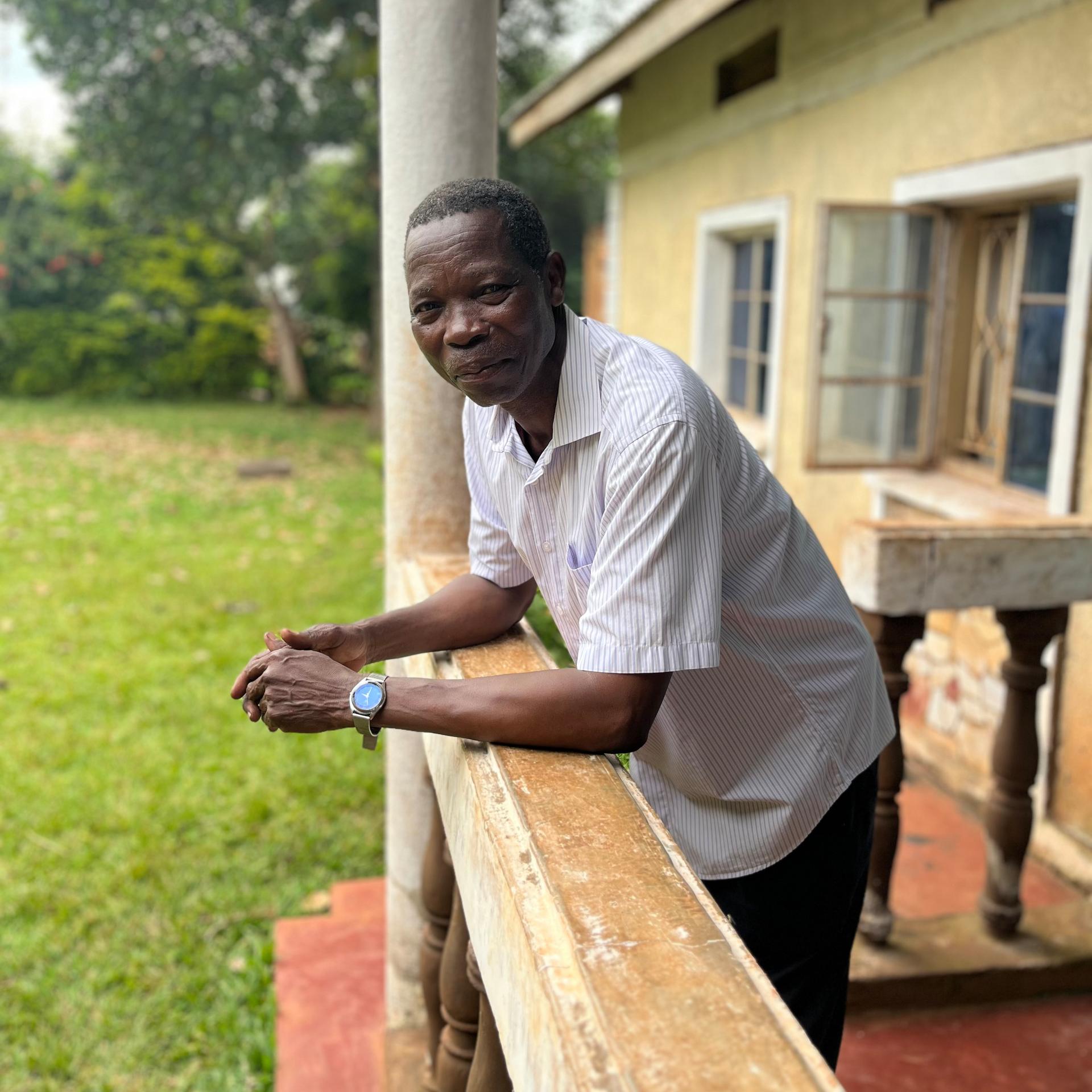 Moses Kutoi, a clan leader of the Bagisu people in eastern Uganda, stands on the balcony of his house on Wednesday. (AP Photo/Rodney Muhumuza)