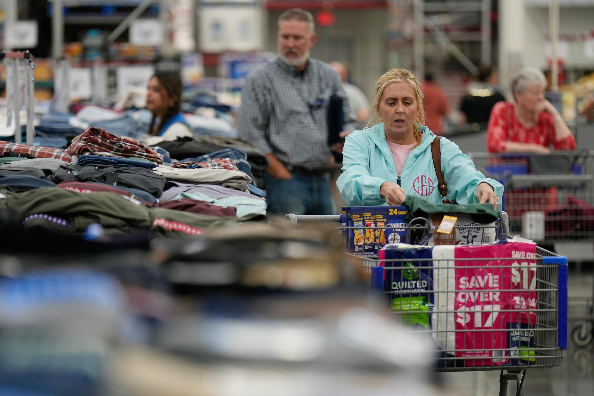 People shop for clothing at a Sam's Club in Bentonville, Ark., on Sept. 24. (AP Photo/Charlie Riedel)