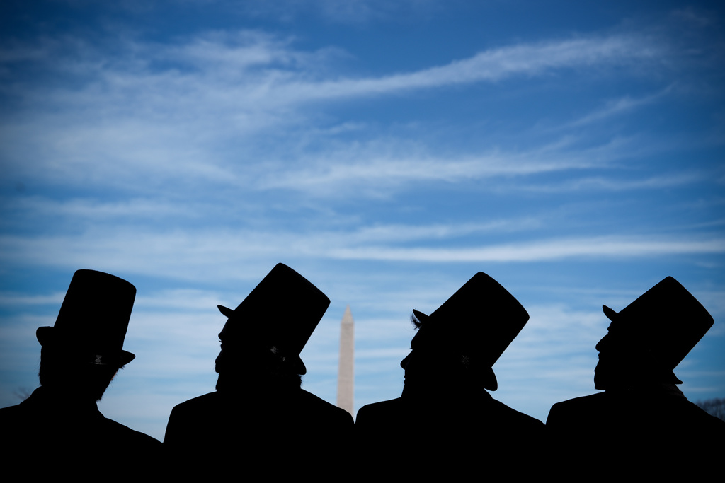 Men dressed as former President Abraham Lincoln attend a mock funeral for the penny, which was discontinued earlier this year, Saturday, Dec. 20, 2025, in front of the Lincoln Memorial in Washington. (AP Photo/Julia Demaree Nikhinson)