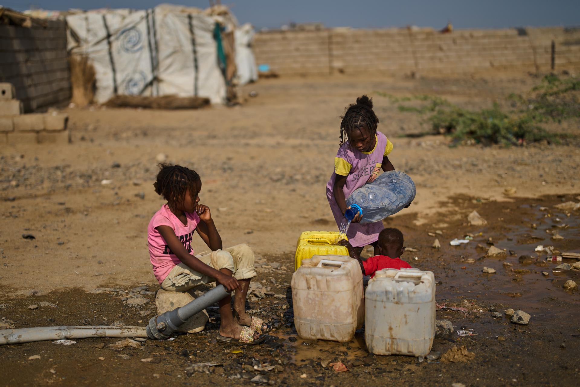 Internally displaced Sudanese children collect water at the Al Heshan camp in Port Sudan, Sudan, Wednesday.
