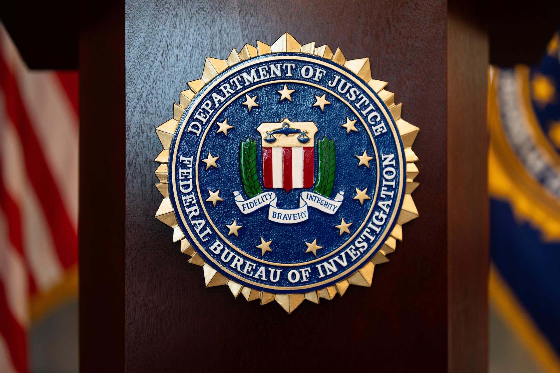 An FBI seal is displayed on a podium at the field office in Portland, Ore., 2025.