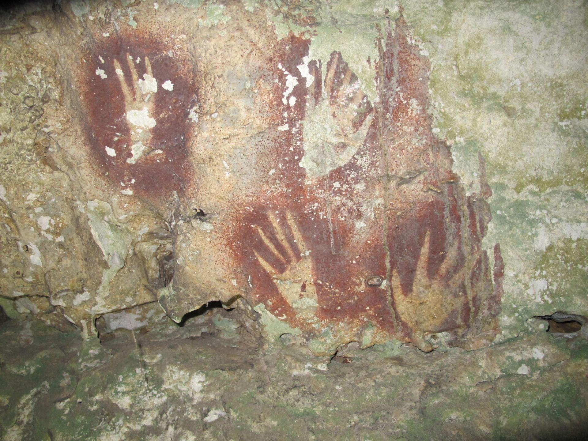 This undated image shows handprints with sharpened fingertips in the Maros region of Sulawesi, Indonesia. (Ahdi Agus Oktaviana/Maxime Aubert via AP)