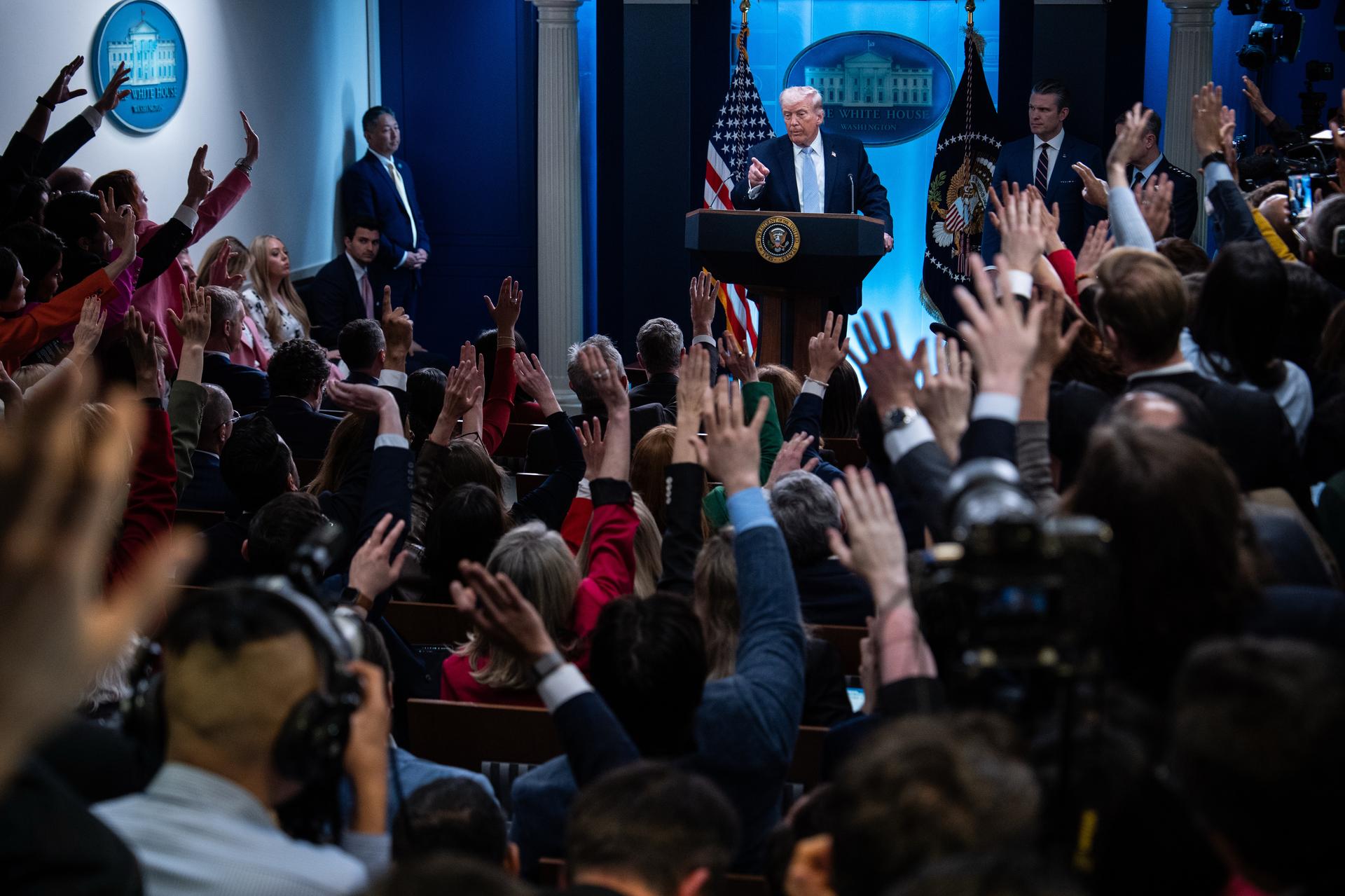 President Donald Trump, accompanied by Defense Secretary Pete Hegseth and Chairman of the Joint Chiefs of Staff Gen. Dan Caine, speaks with reporters in the James Brady Press Briefing Room at the White House on Monday in Washington.