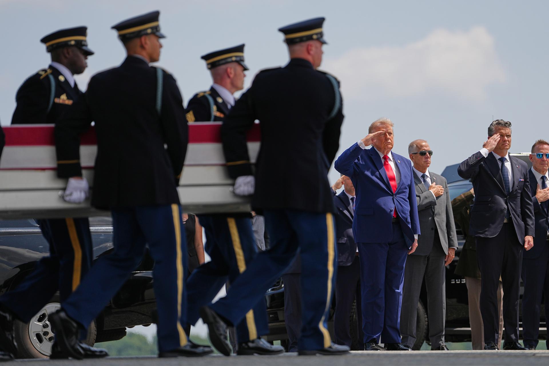President Donald Trump and Secretary of Defense Pete Hegseth salute as a U.S. Army carry team moves a transfer case containing the remains of Pvt. Isabella Gonzales of Carrollton, Texas, July 22, at Dover Air Force Base, Del.