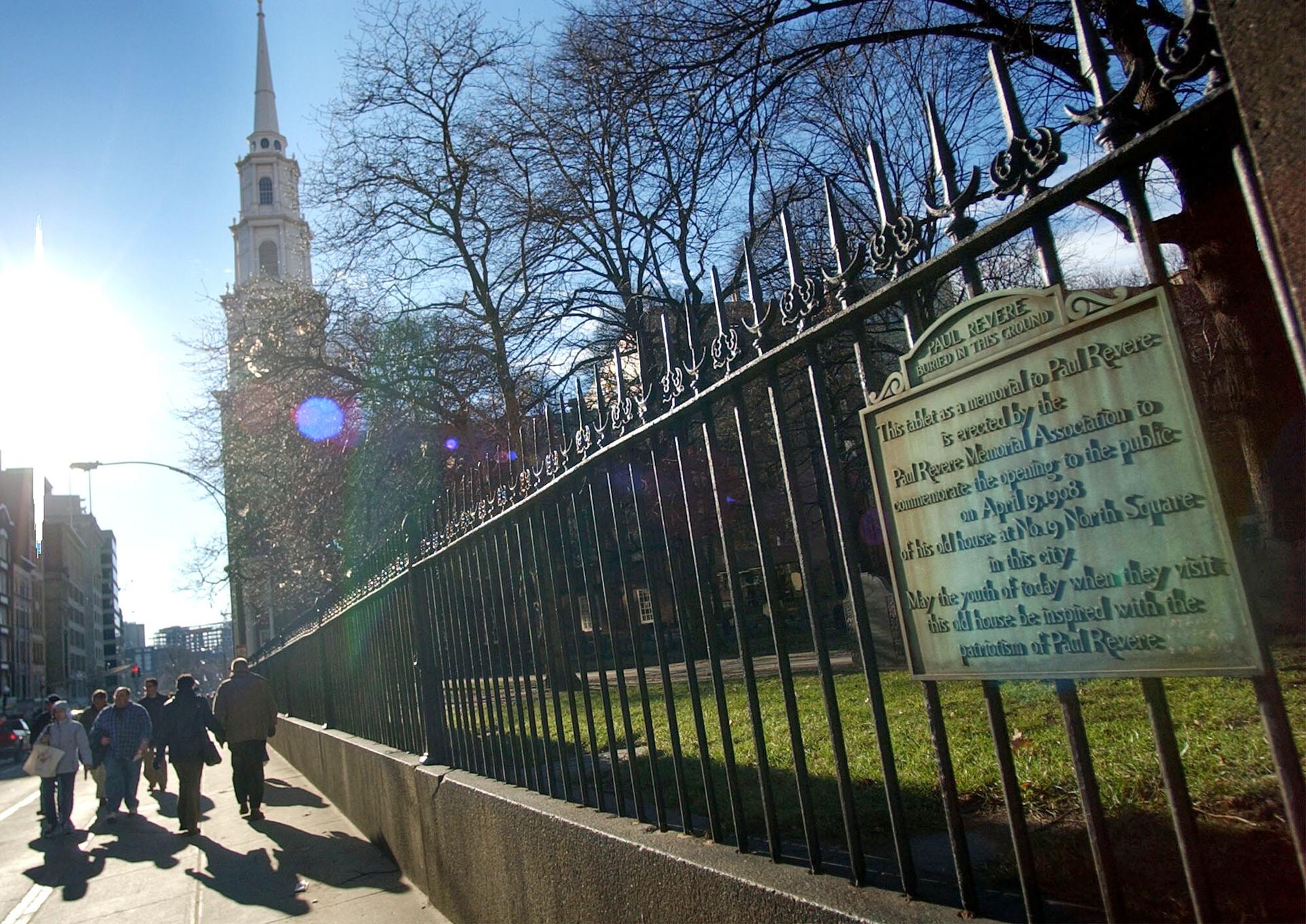 A marker signifying the burial place of Paul Revere appears on the fence at the Old Granary Burying Ground in Boston, 2003. 