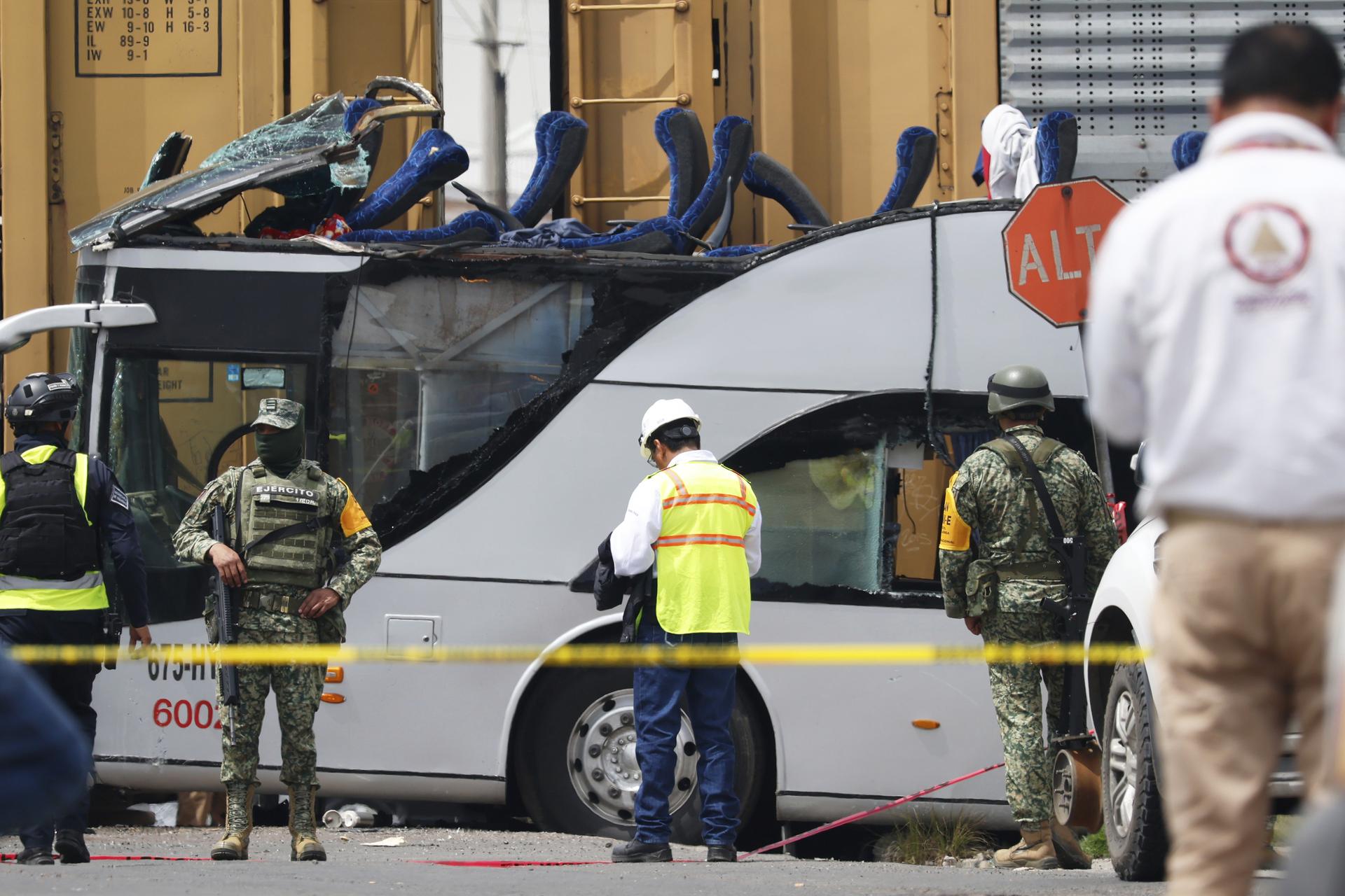 Soldiers and rescue personnel work the scene of a deadly accident in Atlacomulco, Mexico, on Monday. (AP Photo/Ramses Mercado Valdes)