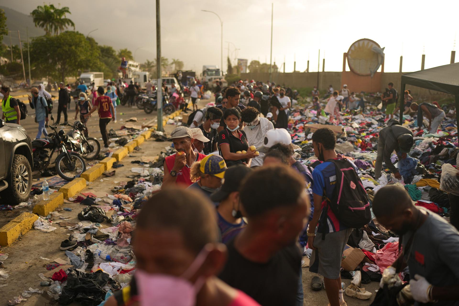 People affected by the earthquake line up for food in La Guaira, Venezuela, on Saturday. (AP Photo/Matias Delacroix)