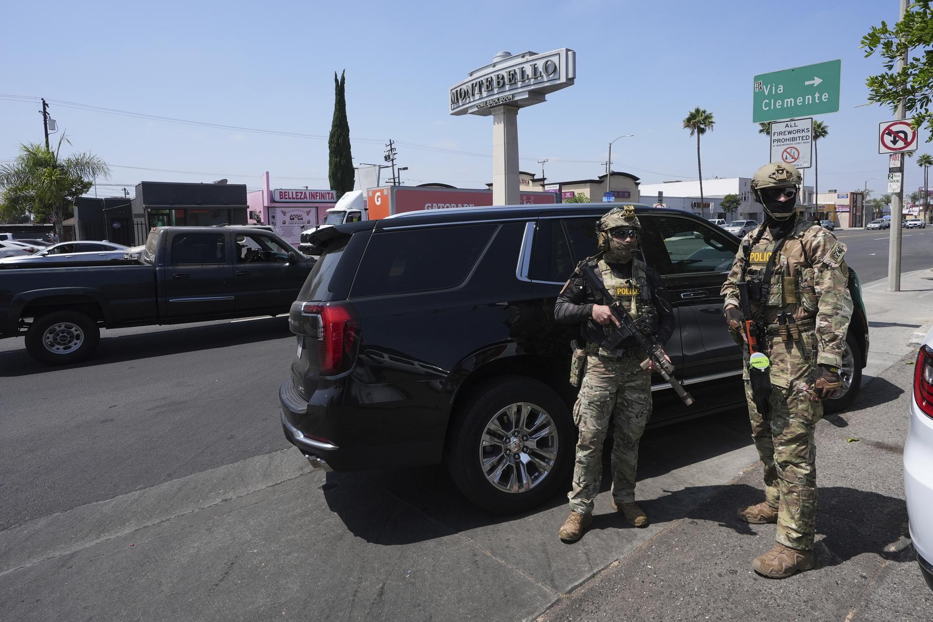 Immigration agents conduct an operation at a car wash in Montebello, Calif. on Aug. 15. (AP Photo/Gregory Bull)