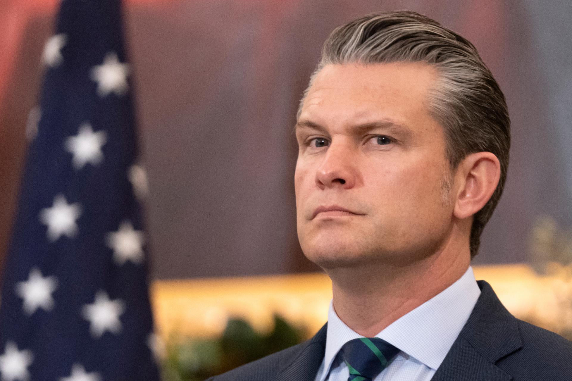 Defense Secretary Pete Hegseth listens during an event at the State Department on Monday. (AP Photo/Mark Schiefelbein)