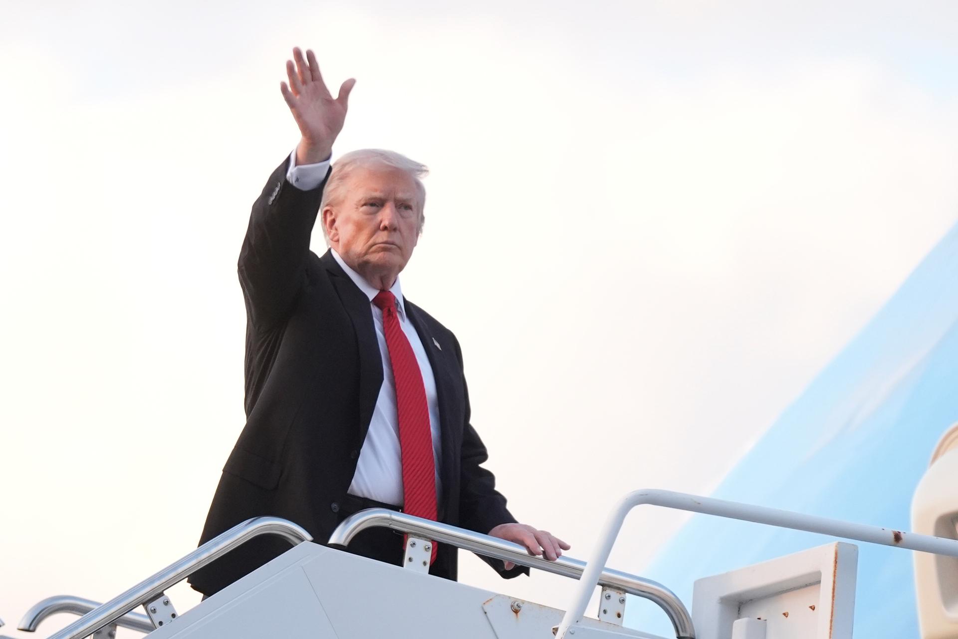 President Donald Trump waves as he boards Air Force One at Palm Beach International Airport in West Palm Beach Fla., on his way back to the White House following a weekend at his Mar-a-Lago estate, Sunday.